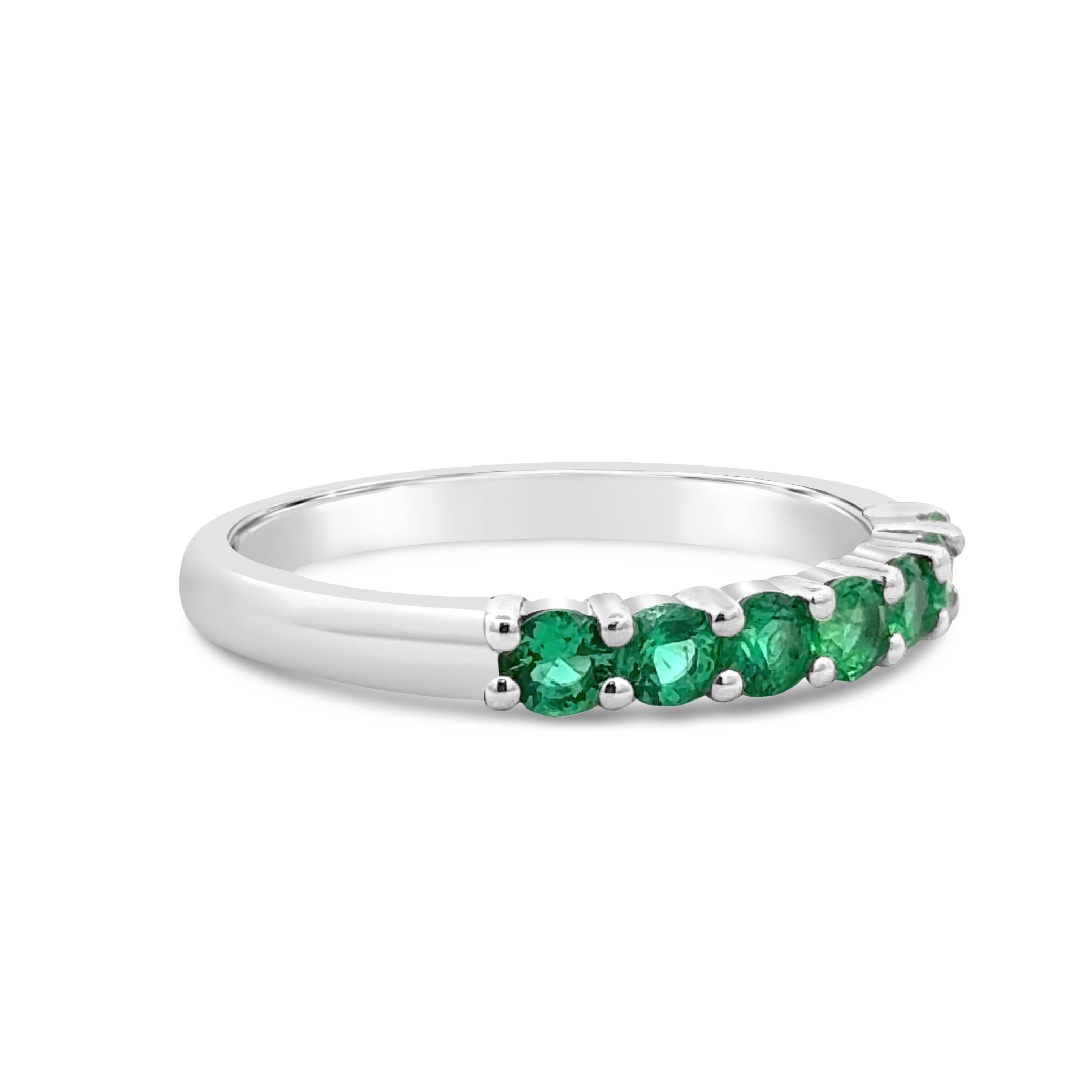 A chic wedding band, featuring seven round cut green emeralds weighing 0.50 carat total, set in a shared prong setting. Made with a platinum mounting, 2.8 mm in width. Size 6 US, resizable upon request.

Roman Malakov is a custom house, specializing