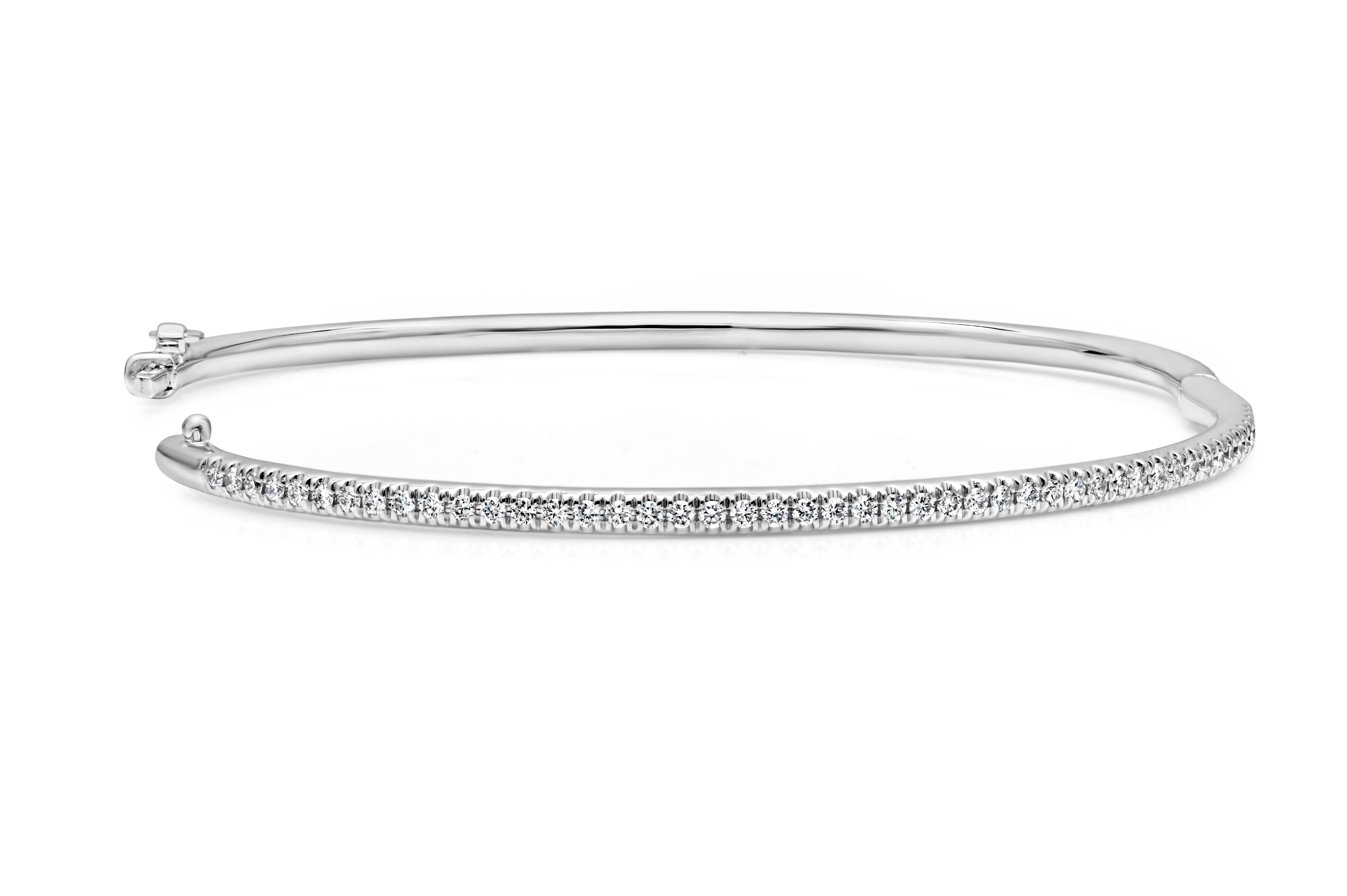 Showcasing a simple but elegant small wrist bangle bracelet set with 47 brilliant round cut diamonds weighing 0.50 carats total, F color and VS in clarity. Has a clasp to slip and wear the bangle securely. Finely made in 14K White Gold and 6.5