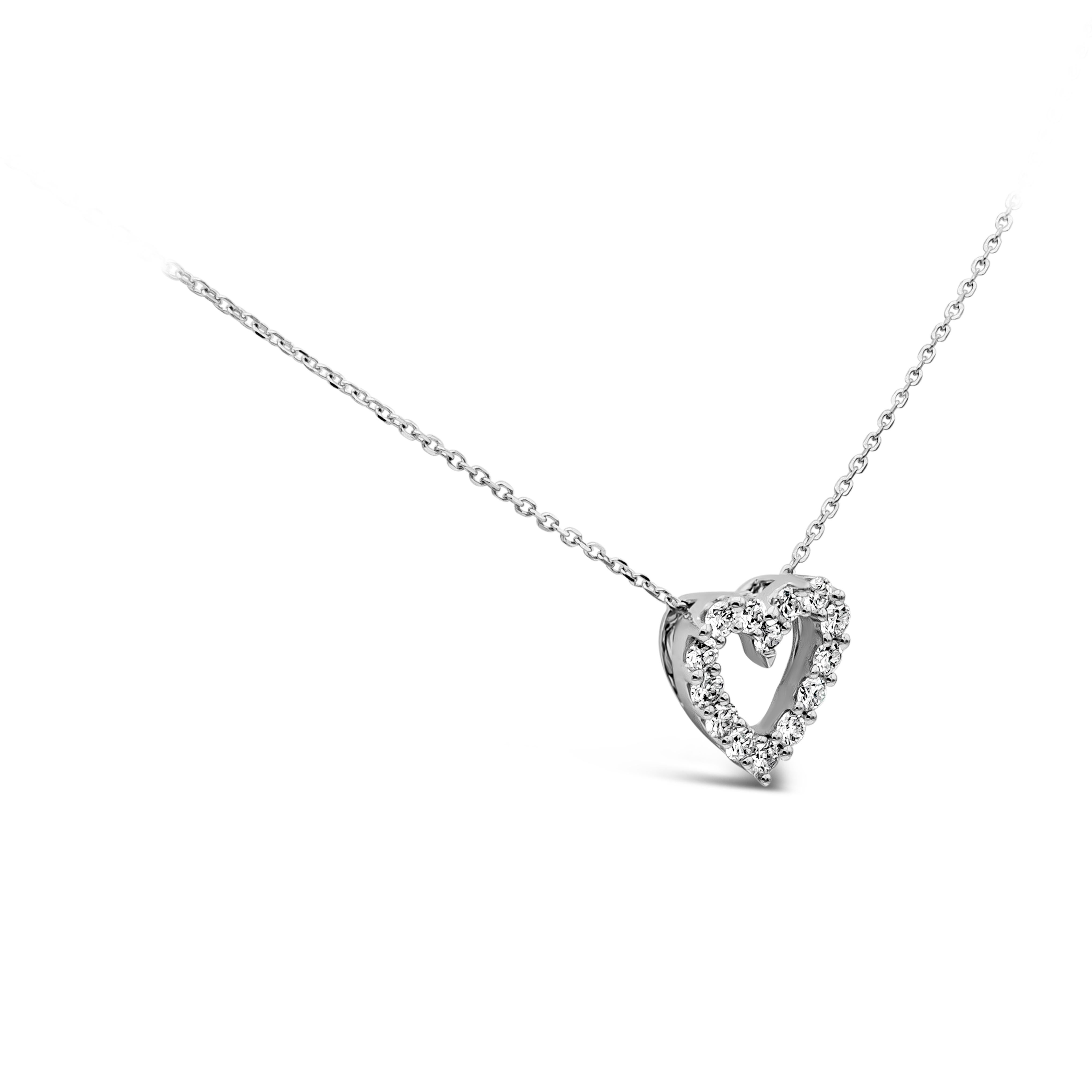 A simple pendant necklace showcasing a row of 14 round brilliant diamonds, set in an open-work heart shape mounting made in 18k white gold. Diamonds weigh 0.53 carats total, G color, VS/SI clarity. Suspended on a 16 inch white gold chain. 

Style
