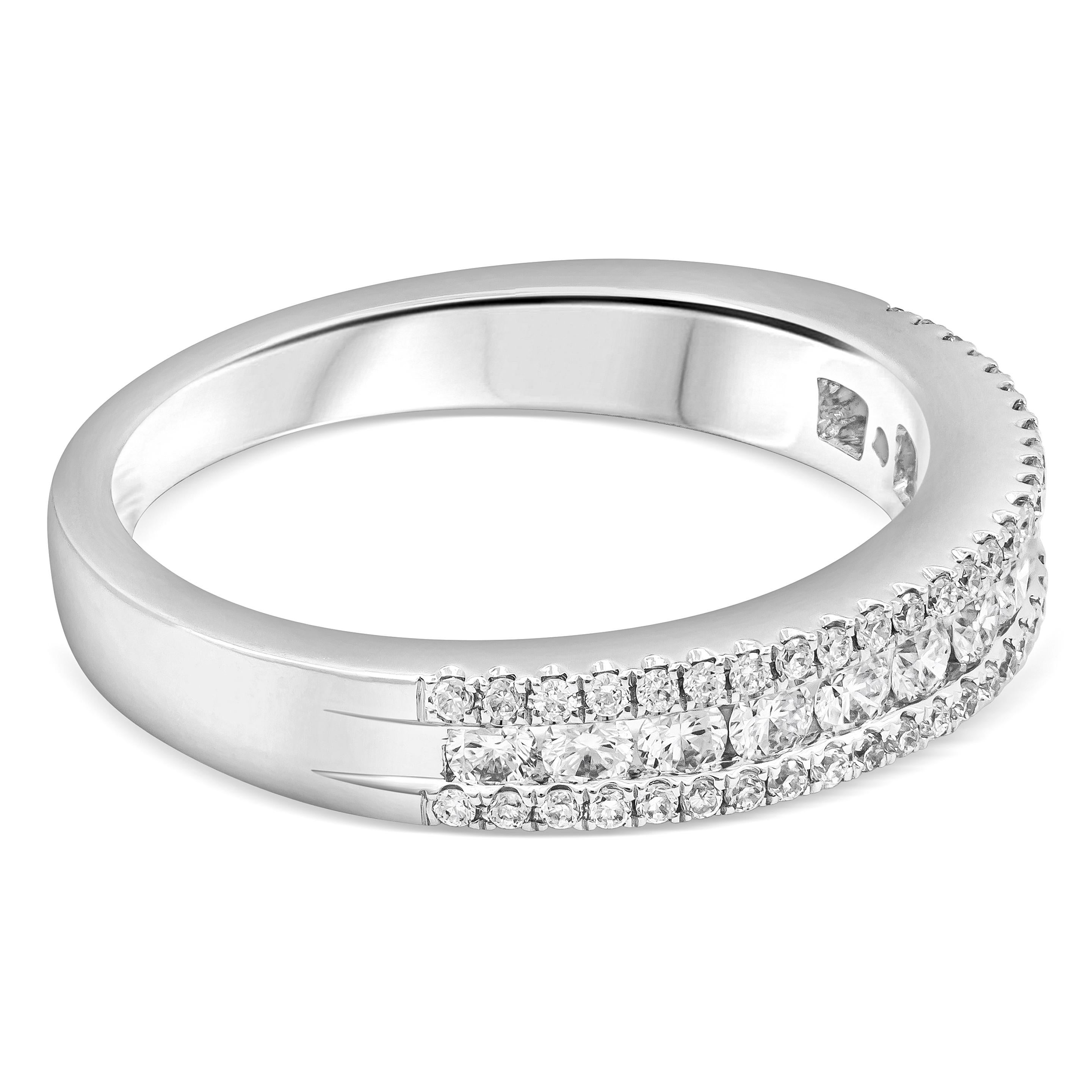 This stylish wedding band features round brilliant diamonds weighing 0.58 carats total. Three-row channel set in half eternity design, flanked with melee brilliant round diamonds on each side. Made with 18K White Gold, Size 6.75 US and resizable