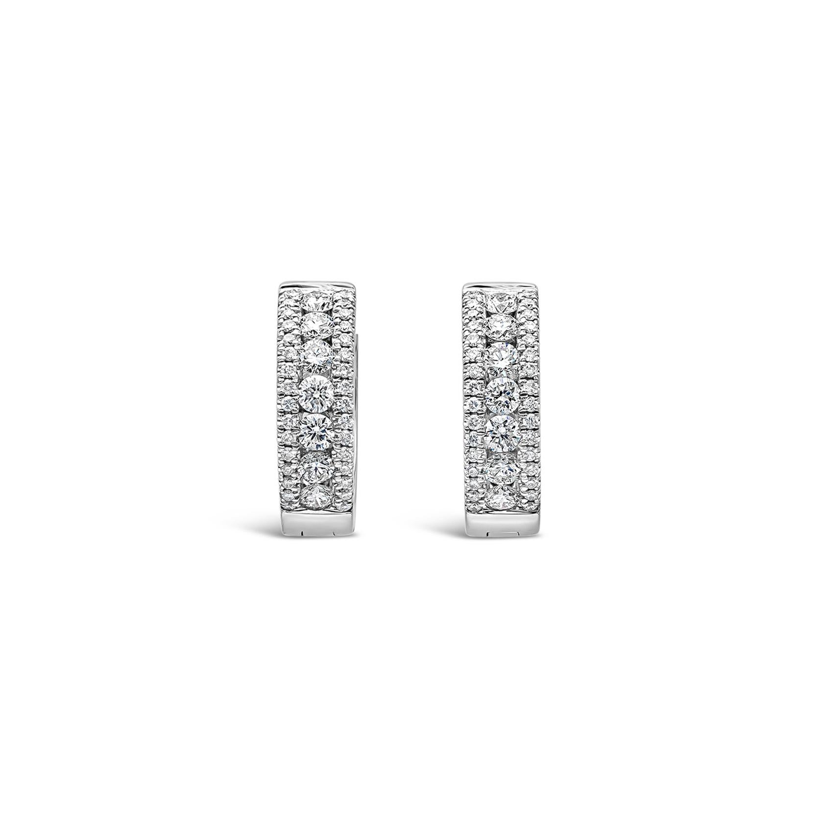 A stylish pair of huggie hoop earrings showcasing a row of round brilliant diamonds, set in an 18k white gold channel setting accented with round melee diamonds. Diamonds weigh 0.63 carats total, F color, VS-SI in clarity.

Roman Malakov is a custom