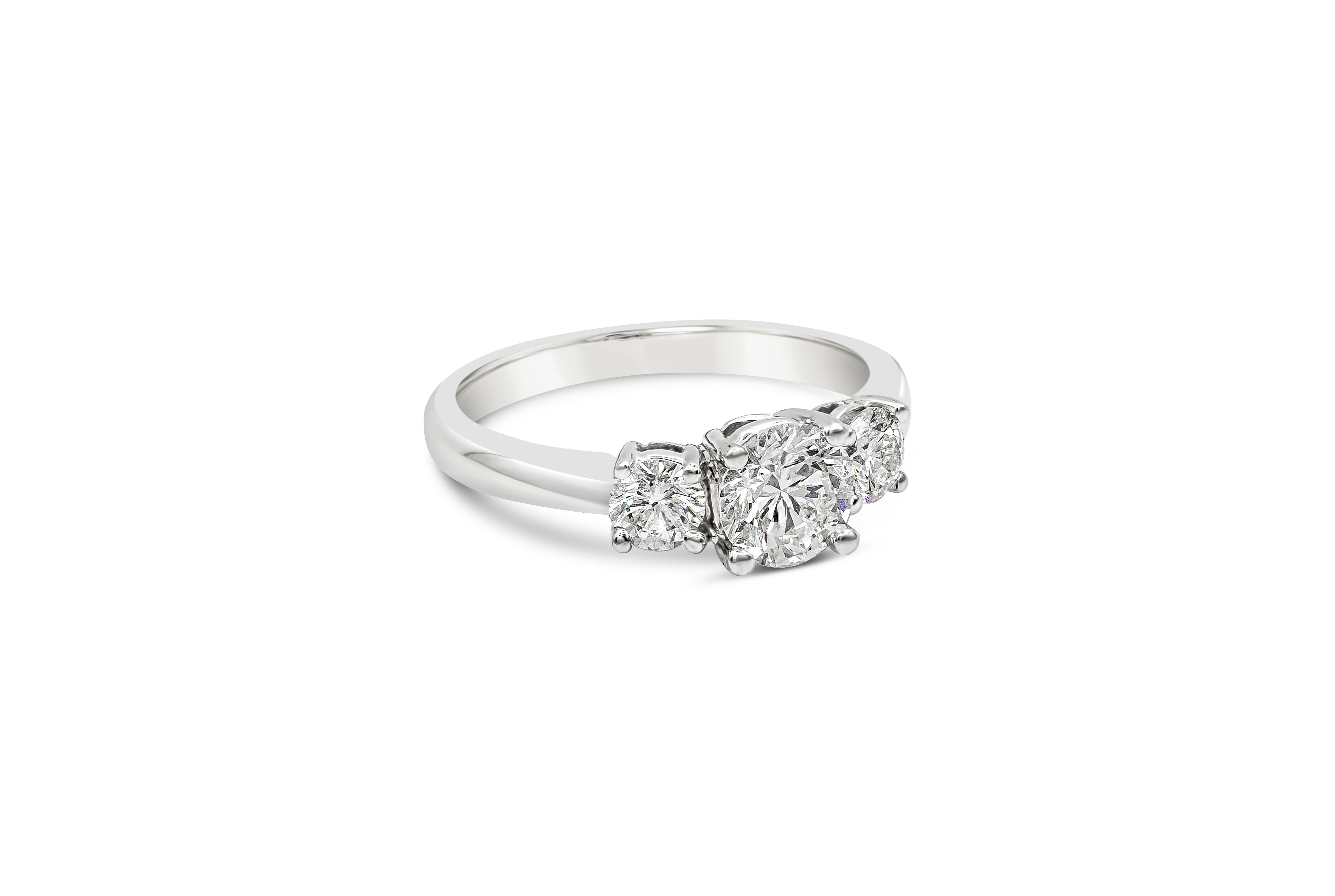 A classic engagement ring style showcasing a 0.70 carat round brilliant diamond, flanked by brilliant round diamonds on either side. Accent diamonds weigh 0.45 carats total. Set in a polished platinum mounting. 

Style available in different price