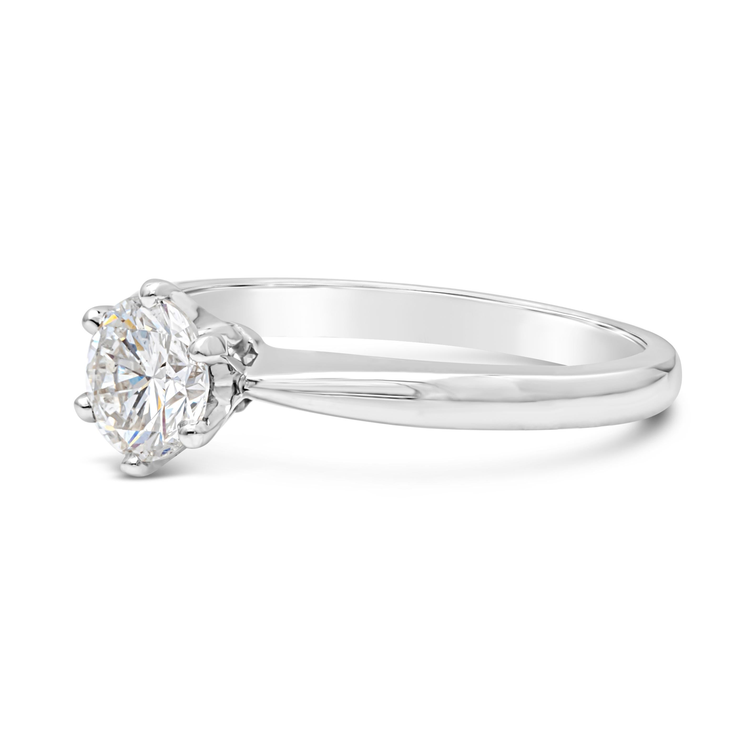 A classic and timeless solitaire engagement ring showcasing a 0.70 carat round brilliant diamond. EGL certified as D Color and SI1 in clarity. Set in a six prong basket setting, finely made in 18K White Gold. Size 6 US and resizable upon