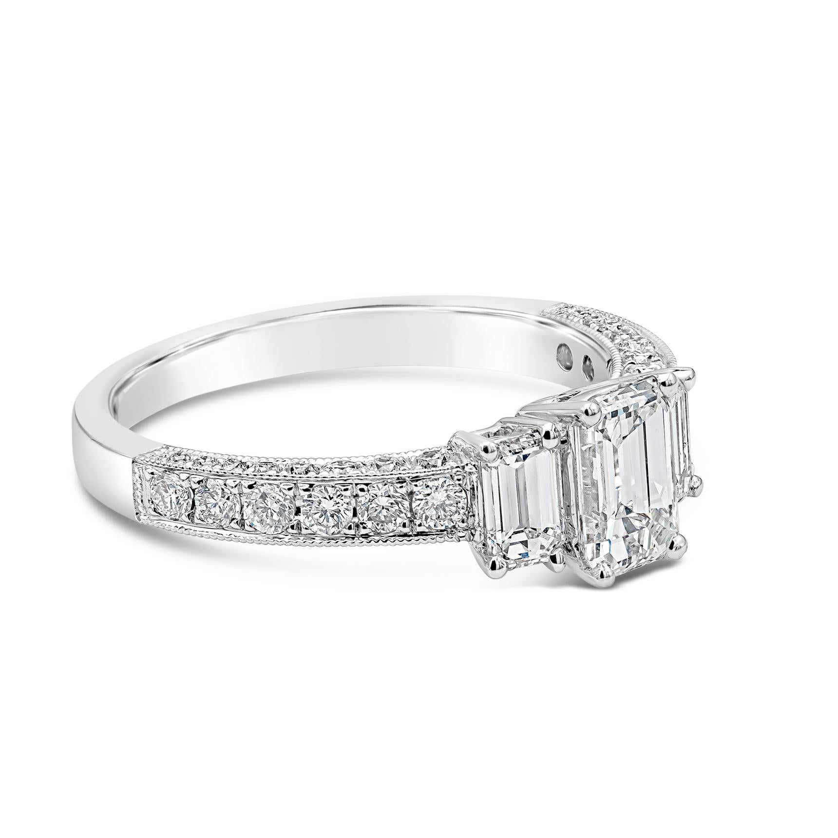 This ring is set with a 0.72 carat emerald cut diamond engagement ring flanked by an emerald cut diamond side stone on each side. Total weight of the side stones is 0.45 carats. 0.48 carats (total) of round brilliant diamonds are also set on the