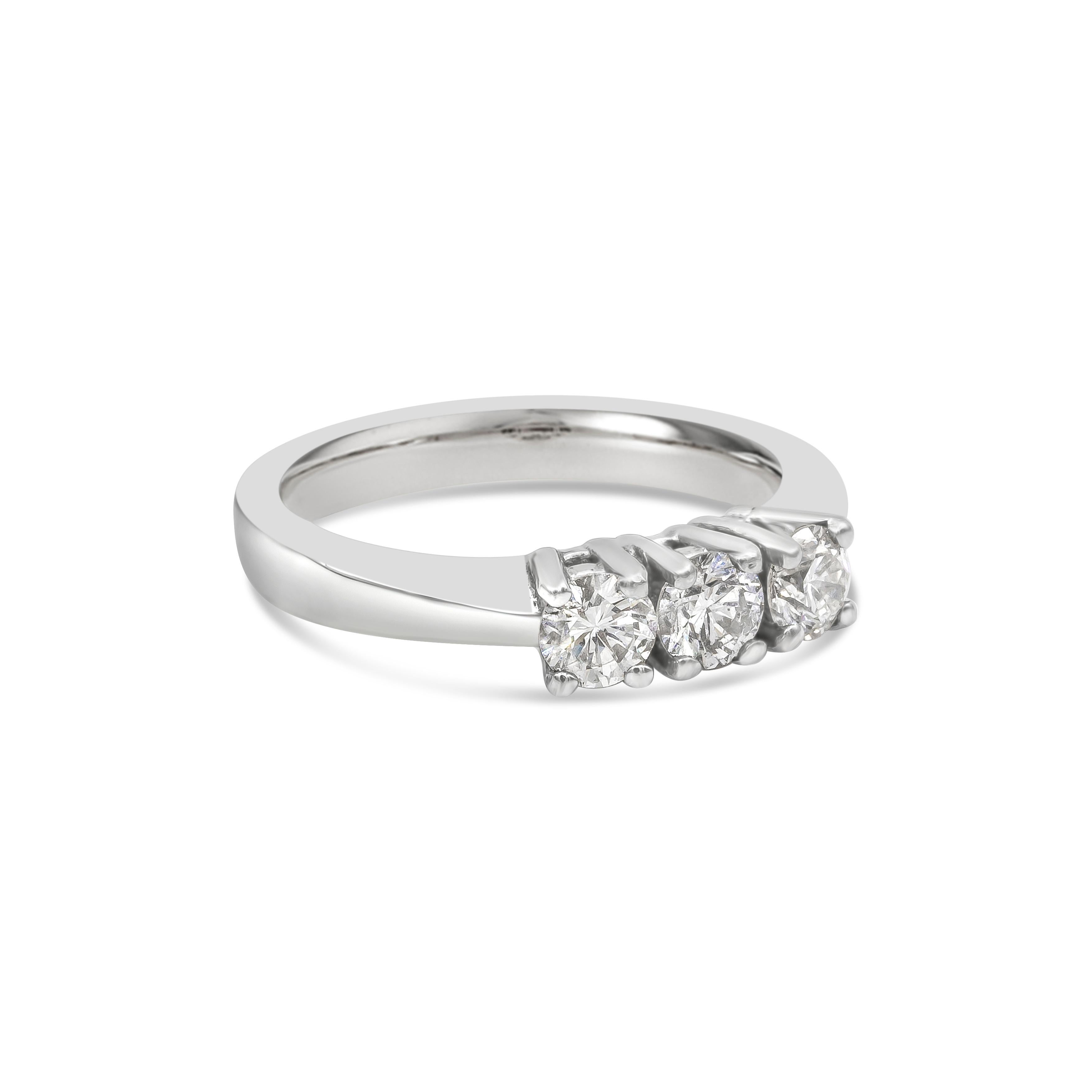 A timeless engagement ring, showcasing three round brilliant cut diamonds weighing 0.72 carat total. Each diamond is set on a four prong setting. Finely made with a platinum mounting. Size 5.75 US, resizable upon request. 

Roman Malakov is a custom