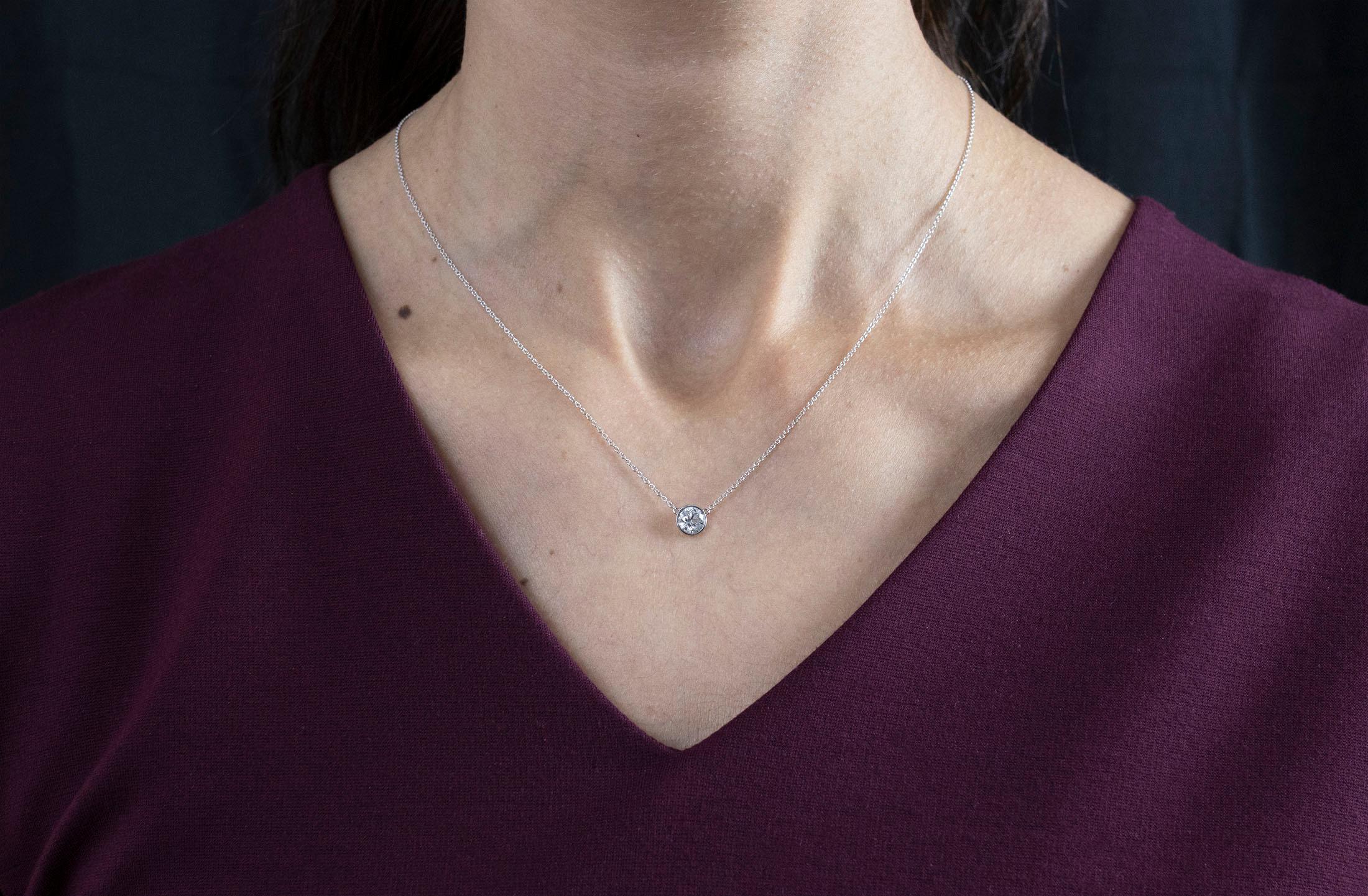 A simple solitaire pendant necklace, showcasing a 0.74 carat round cut diamond, bezel-set in 14K white gold. Suspended on a white gold chain, 15 inches in length. Perfect for everyday wear.

Roman Malakov is a custom house, specializing in creating
