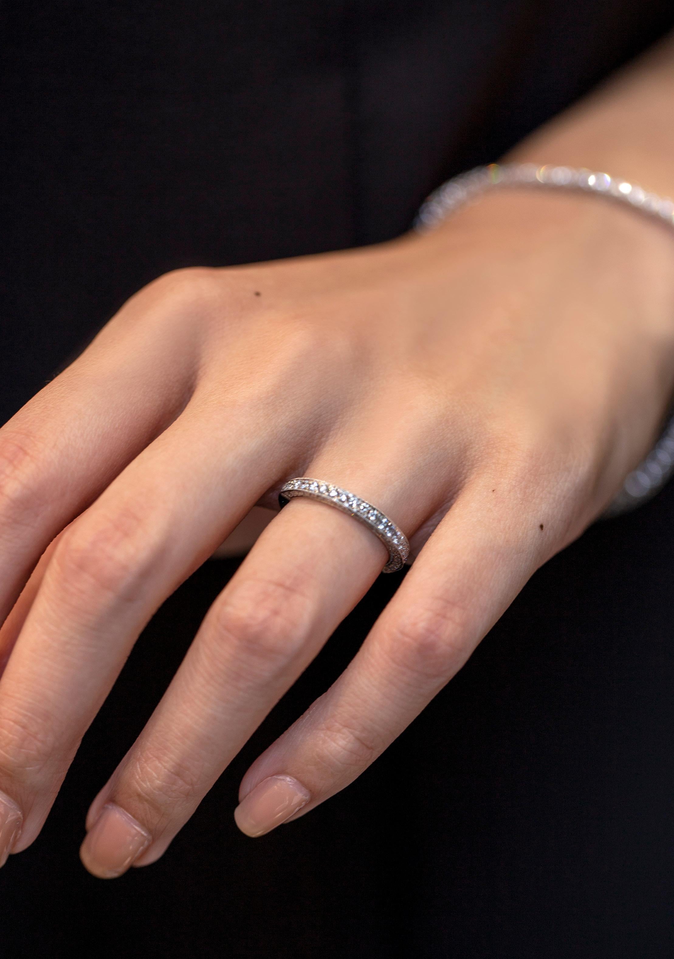 Showcasing 0.74 carats total of round brilliant diamonds set in the front, top and bottom. Diamonds set half-way around the band. Made with 18K White Gold Size 6.5 US

Roman Malakov is a custom house, specializing in creating anything you can