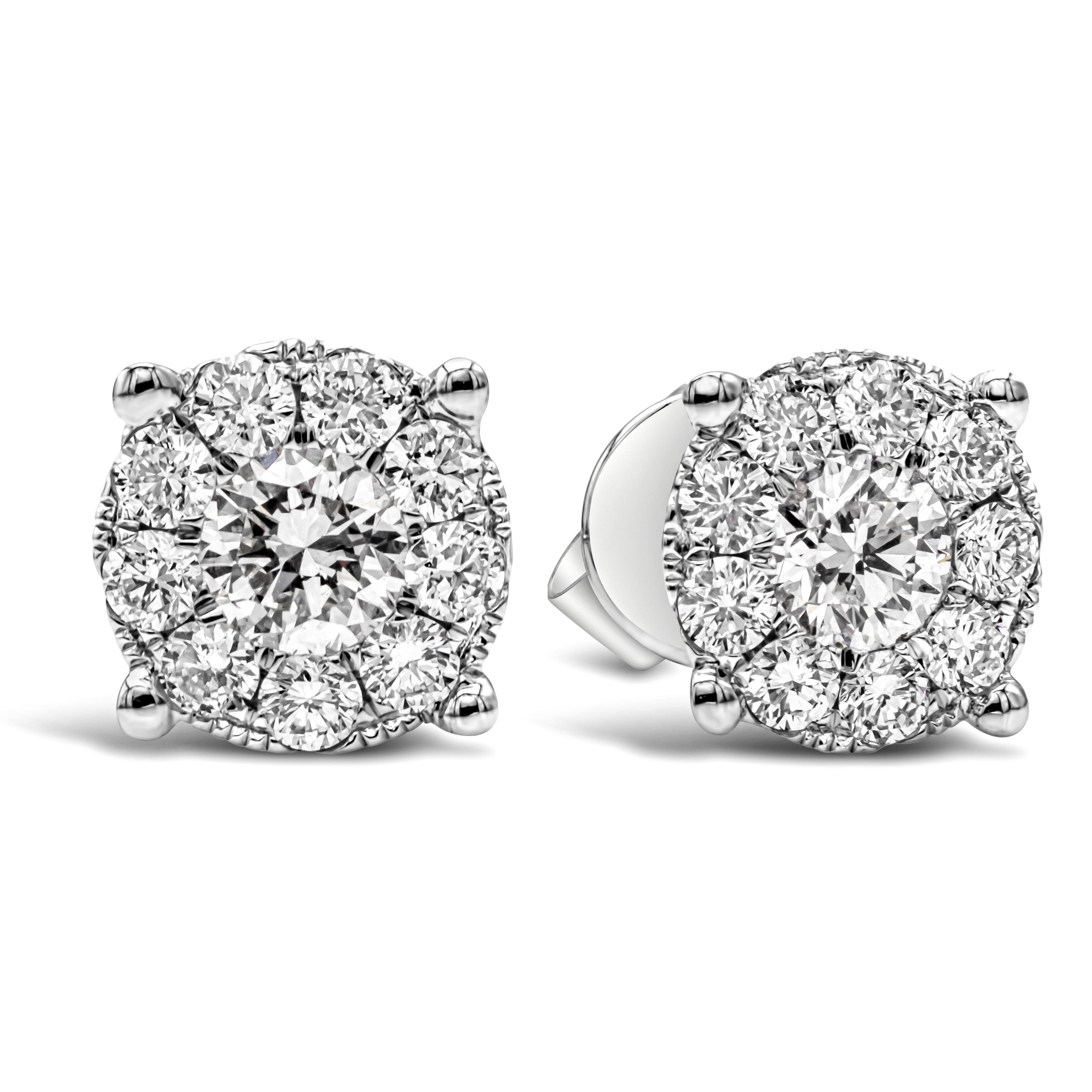 A classic pair of stud earrings showcasing a cluster of 20 round brilliant diamonds set in an 18k white gold. Diamonds weigh 0.74 carats total and are approximately F-G color, VS-SI in clarity. 7mm in diameter, Faces up like a 1.25 carats