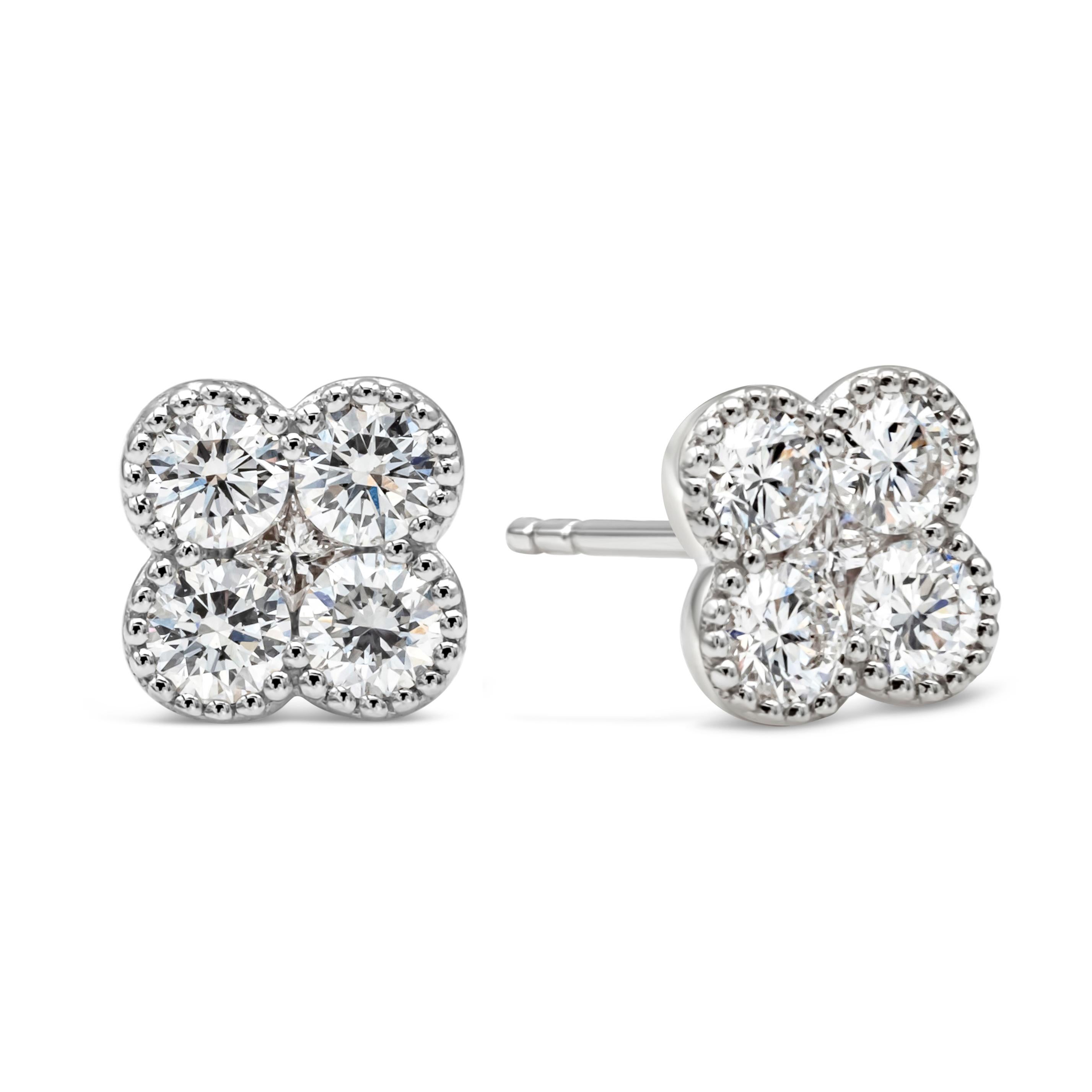 A simple and chic pair of stud earrings showcasing a cluster of round brilliant diamonds weighing 0.75 carats total, F color and VS in clarity, arranged in a beautiful clover design and shared prong basket setting. Finely made in 18k white