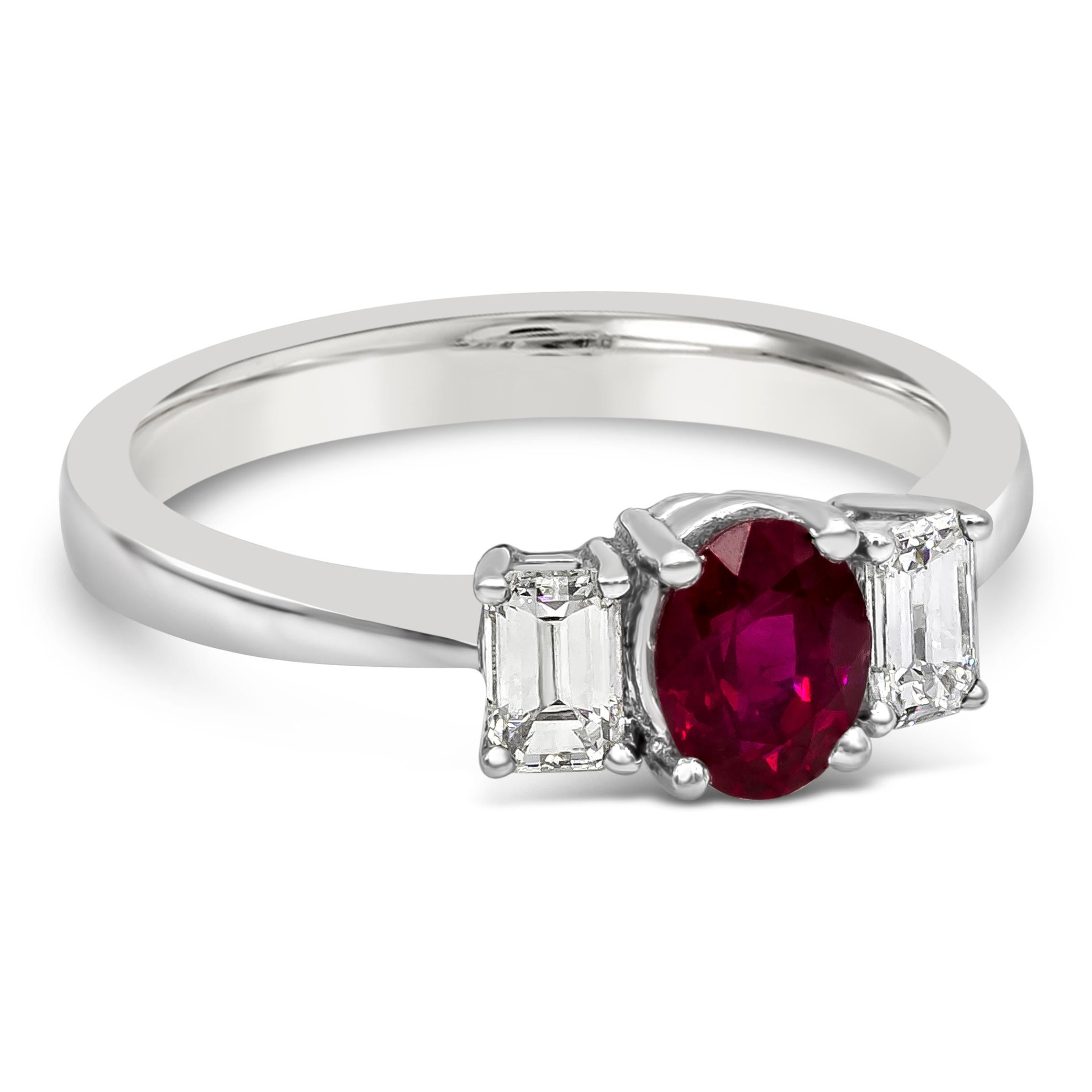 A beautiful gemstone three stone engagement ring style showcasing an oval cut ruby center stone weighing 0.70 carats total. Flanked by an emerald cut diamond on each side weighing 0.41 carats total. Made in 18K White Gold, Size 6.5 US

Roman Malakov