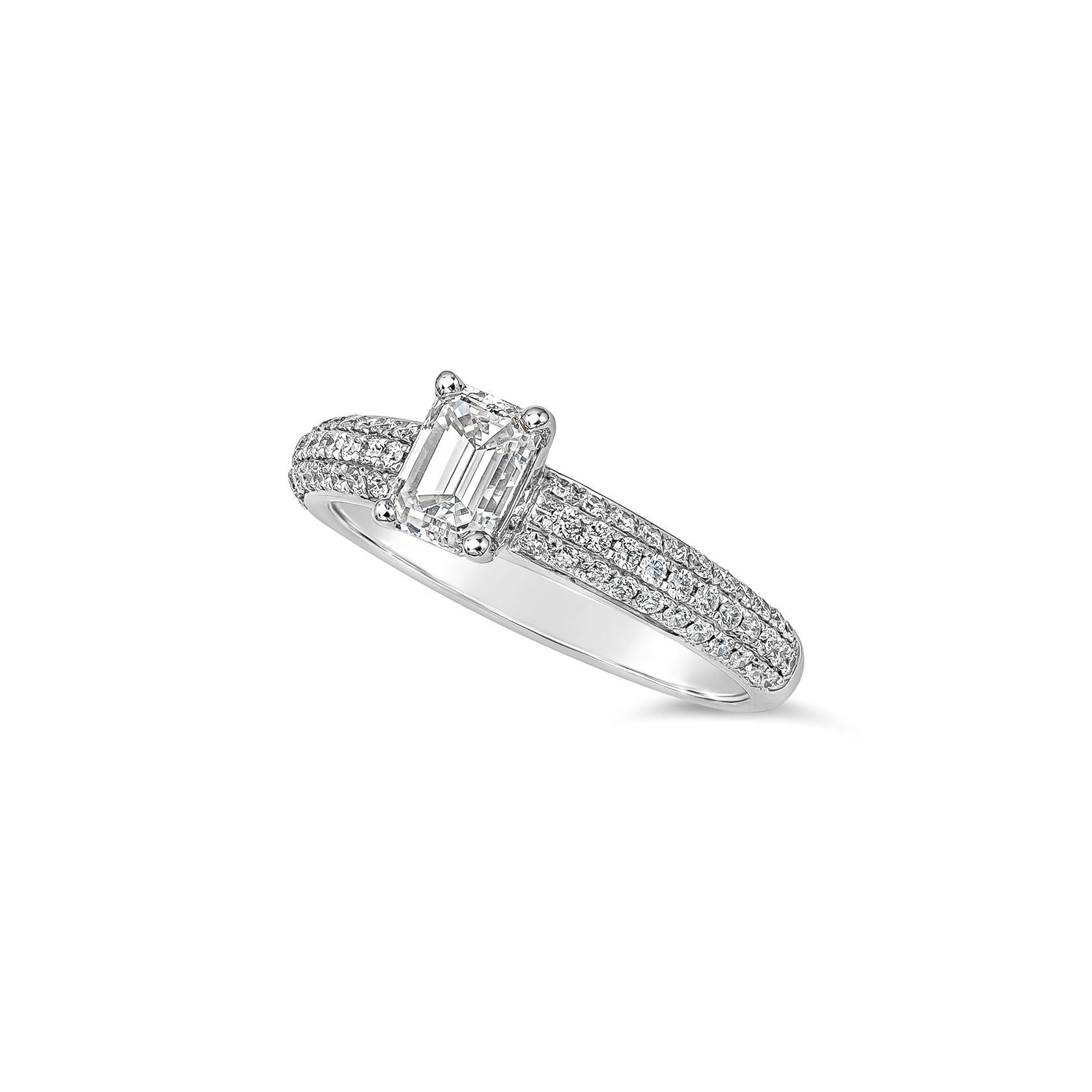A classy engagement ring, featuring a 0.80 carat emerald cut diamond, set on four rounded prongs. Accented by a diamond encrusted shank of three rows of round brilliant melee diamonds weighing 0.36 carat total, set on a micropavé setting with a