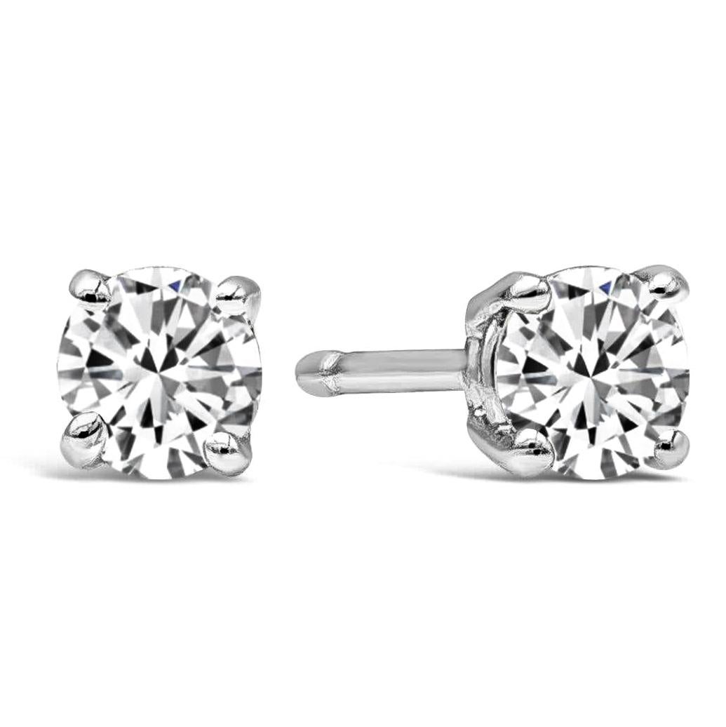 A classic pair of stud earrings showcasing two round brilliant diamonds weighing 0.81 carats total, E-F Color and SI1 in Clarity. Set in a simple four prong basket setting and Finely made in 14K White Gold.

Style available in different price
