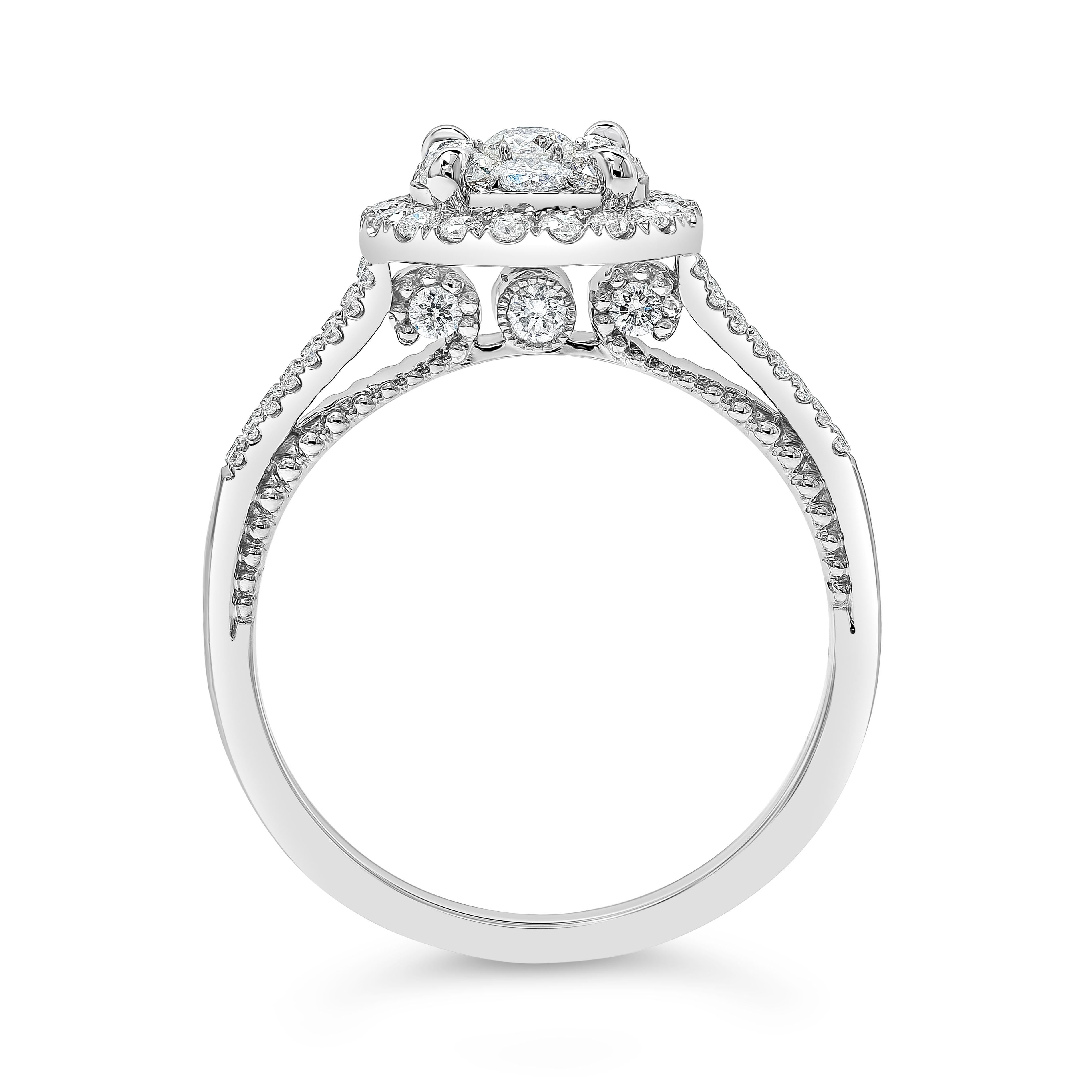 Showcasing a cluster of brilliant round cut diamonds, set in a diamond halo, split-shank mounting made in 14k white gold. Diamonds weigh 0.82 carats total and are approximately G-H color, VS-SI clarity. Finely made in 14k white gold and Size 6.25 US