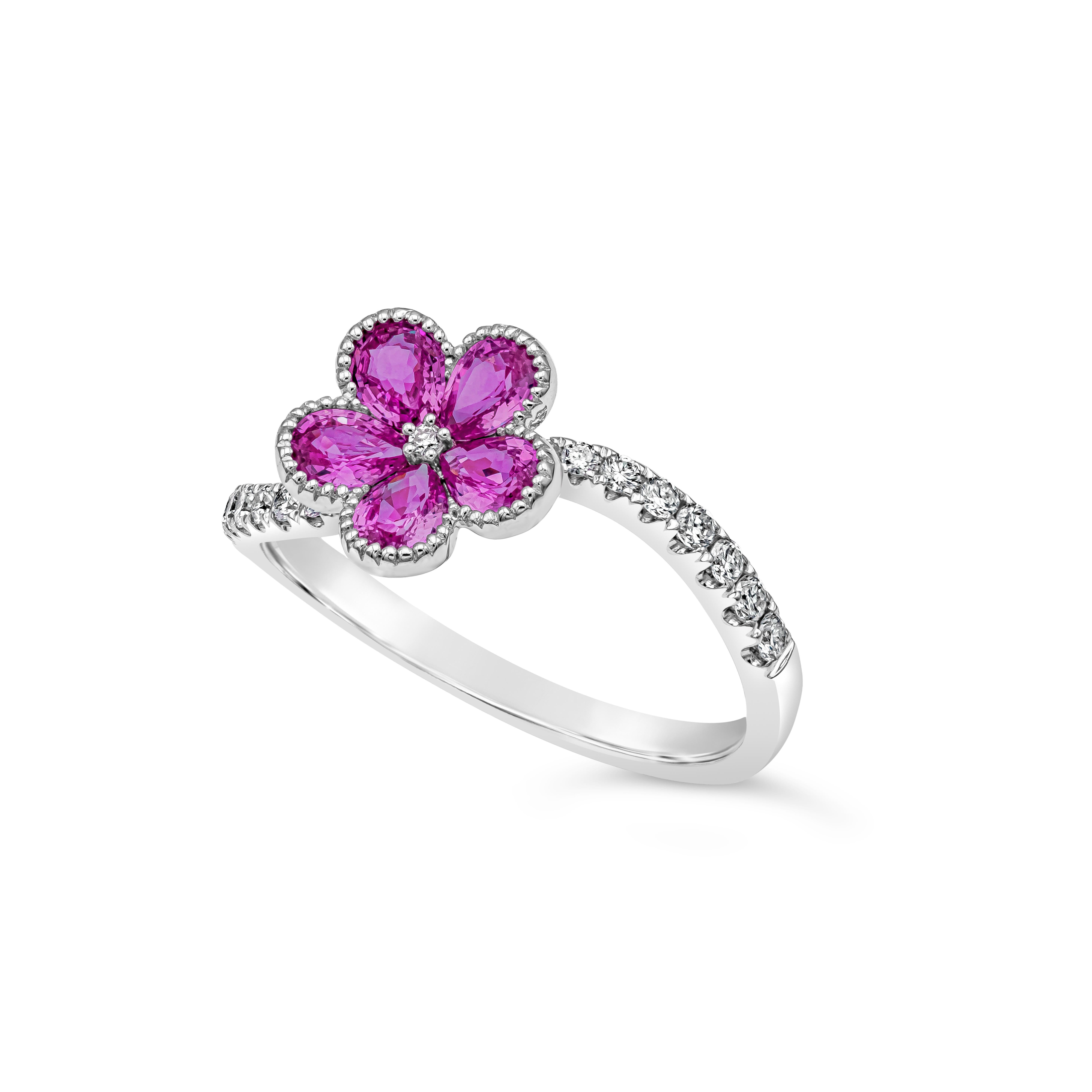 Showcasing a color-rich cluster of five pear shape pink sapphire weighing 0.86 carats total forming a beautiful flower design. Accented with 17 round brilliant diamonds that continues on to the shank of the ring weighing 0.20 carats total, F-G