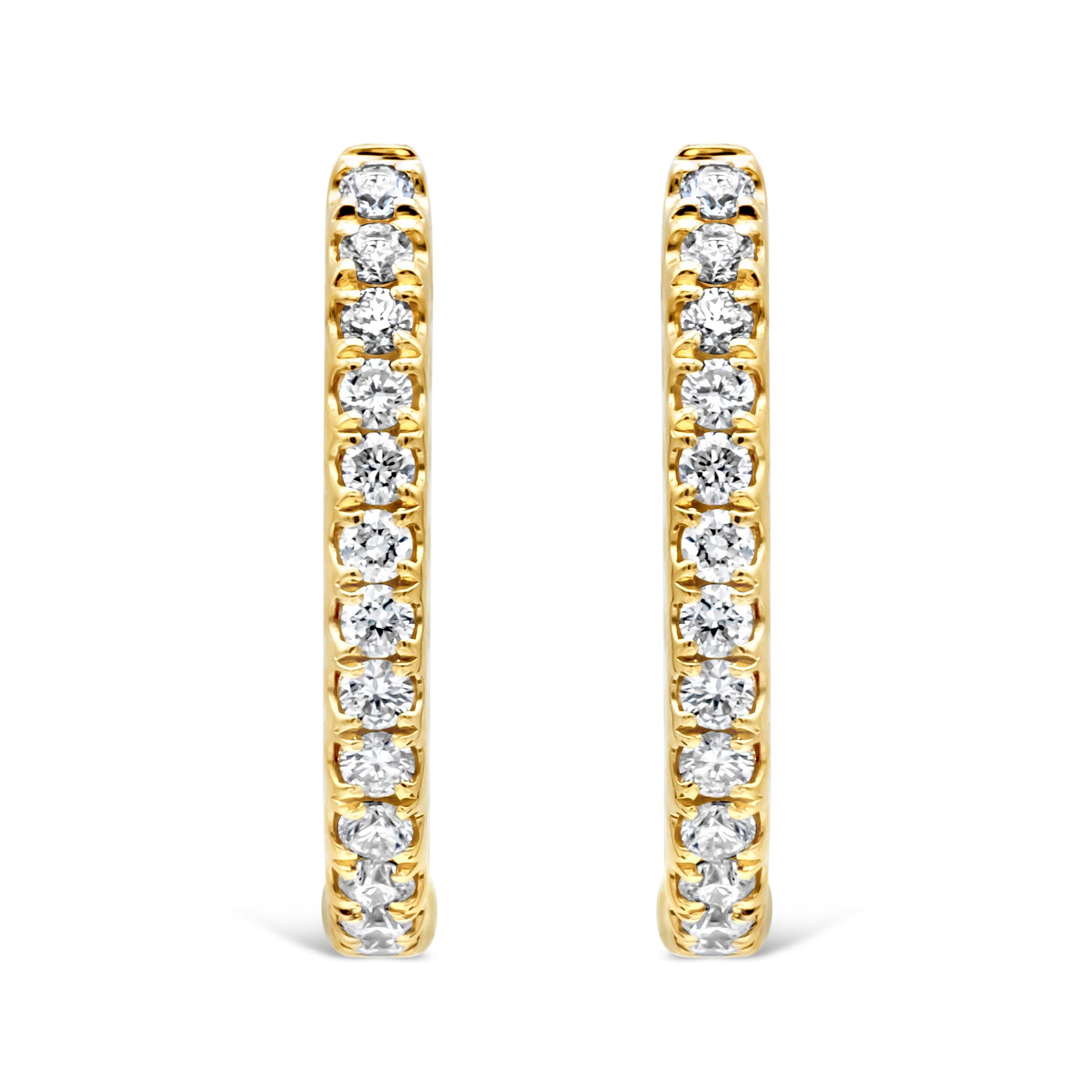 A classic style hoop earrings showcasing a 44 brilliant round shape diamond weighing 0.91 carats total, F-G color and VS-SI1 in clarity, set inside and out in a traditional four prong setting. Finely made in 18K Yellow Gold.

Style available in