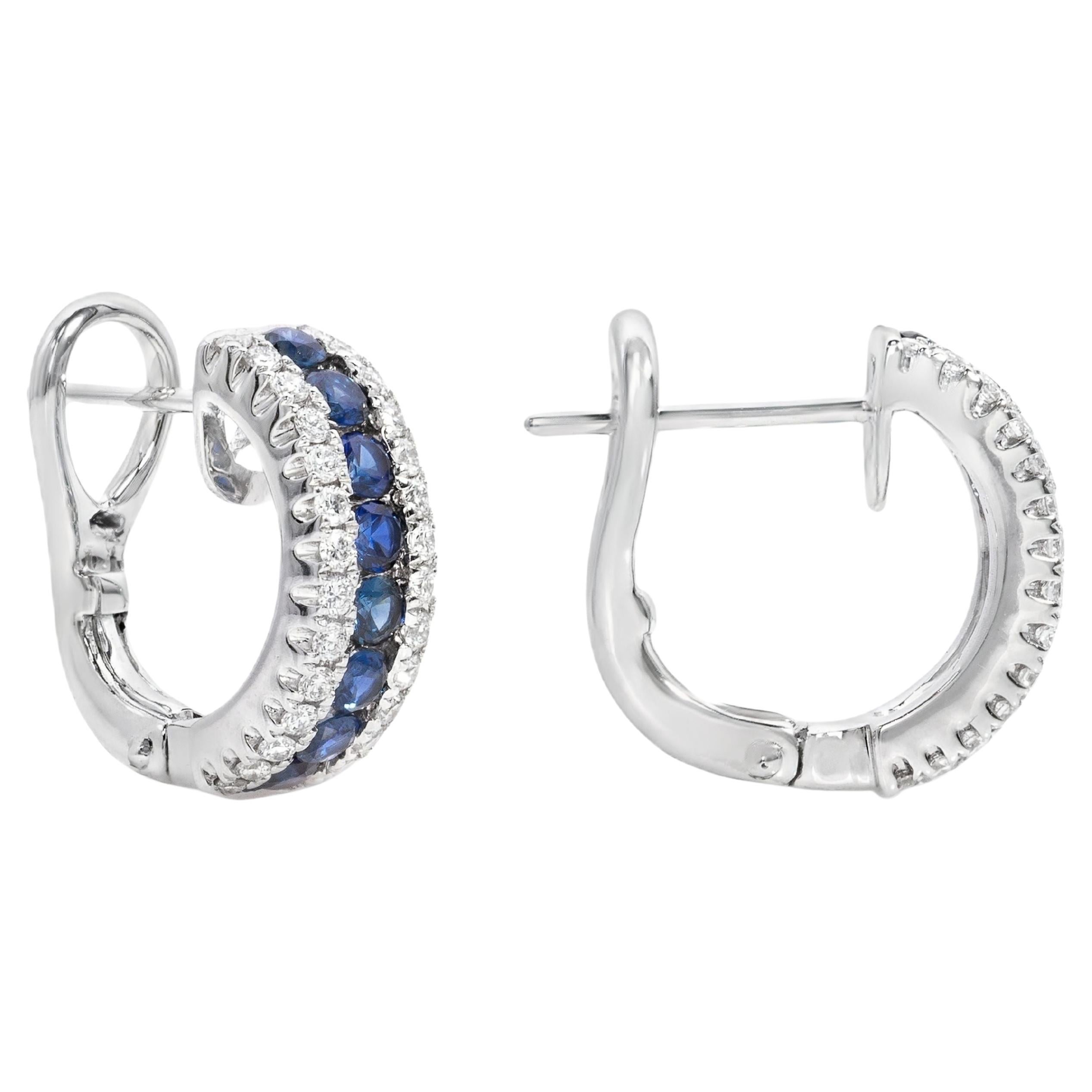 A lovely pair of huggie earrings, featuring round cut sapphires weighing 0.63 carat total, set on a beautiful pavé design in between two rows of round brilliant cut diamonds weighing 0.30 carat total. Finely made with 18K white gold. Perfect for