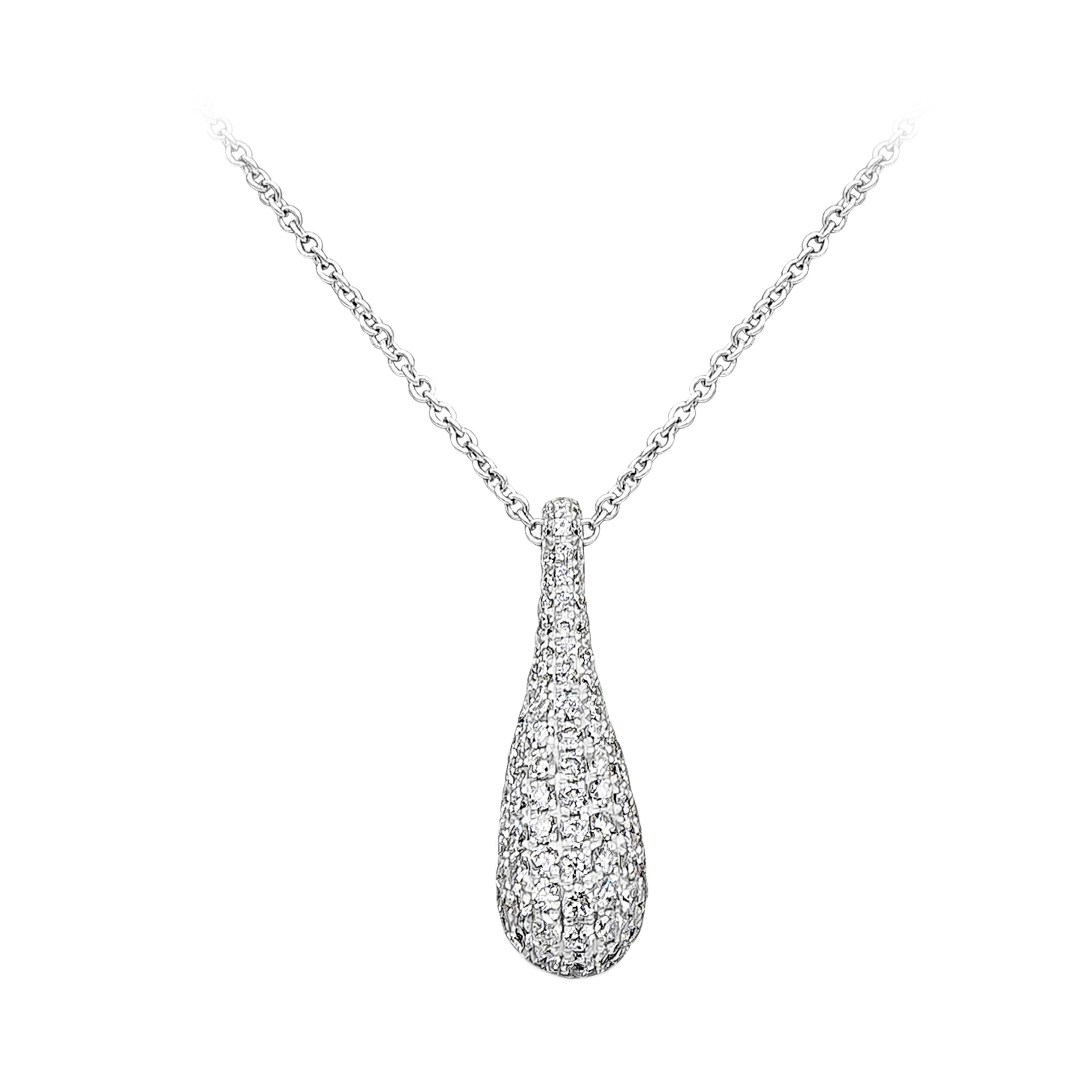A fashionable and stunning pendant necklace showcasing 110 brilliant round cut diamonds weighing 0.94 carats total, set in a beautiful dome micro-pave set and classic four prong setting. Suspended on an 18 inches adjustable chain and finely made in