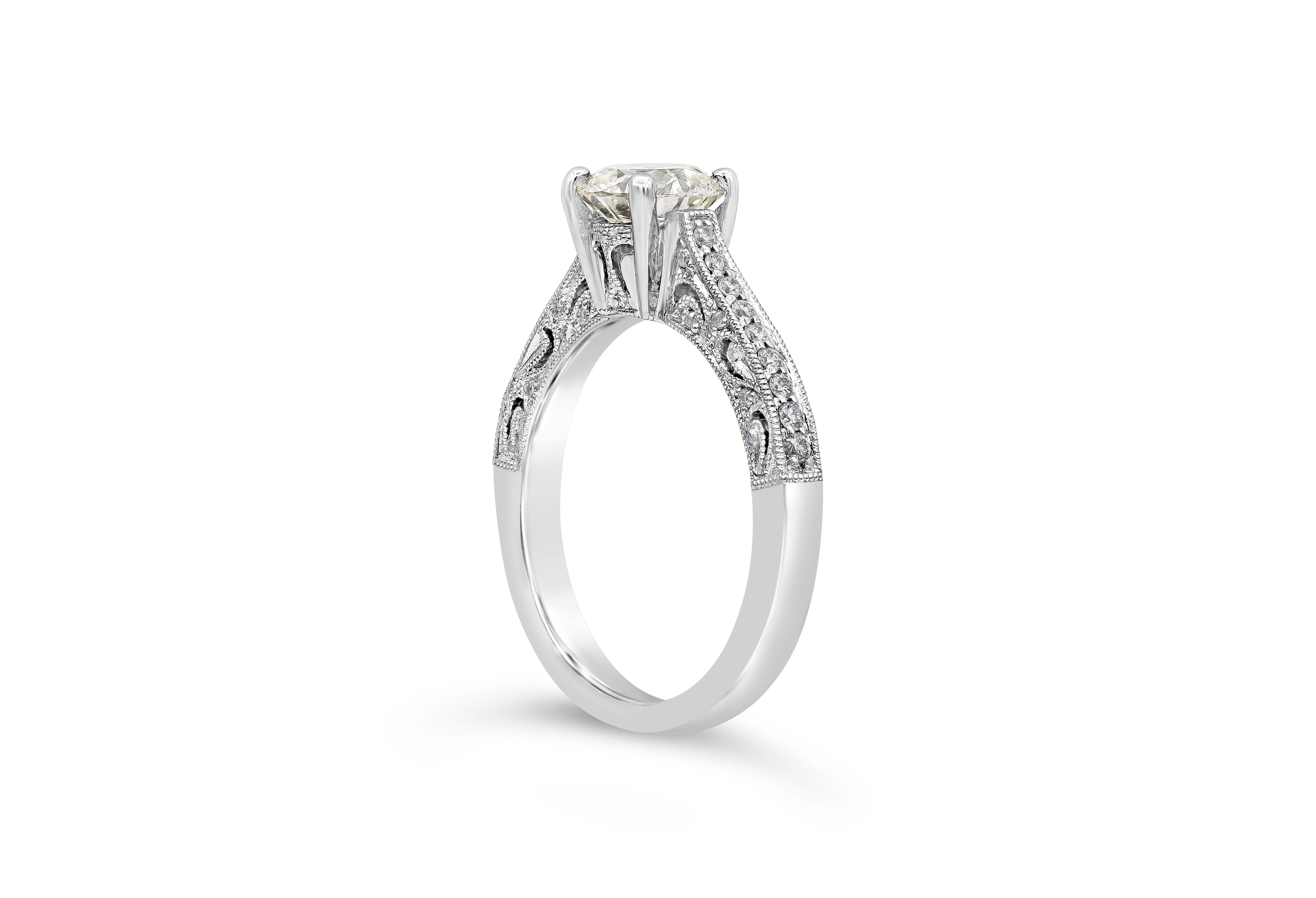 This simple and vintage engagement ring style handcrafted in 18k white gold features a 1.07 carats round brilliant diamond certified by GIA as L color, VS2 in clarity, accented by round brilliant diamonds on either side. Finished with filigree and