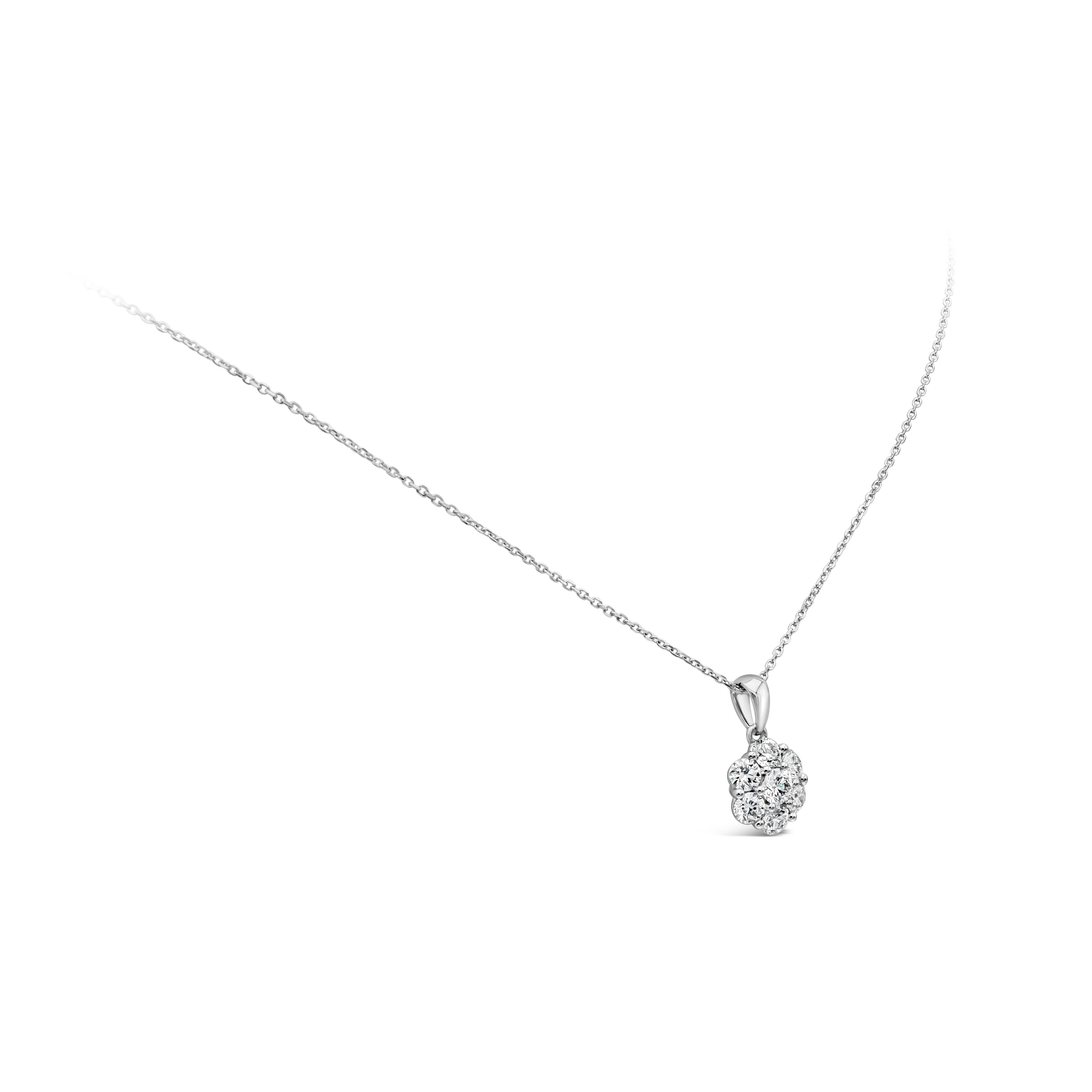 A simple yet beautiful pendant necklace showcasing a cluster of 7 brilliant round diamonds, arranged in a flower design made in 18k white gold. Diamonds weigh 1 carats total and are approximately G color, VS-SI clarity. Made in 18k white