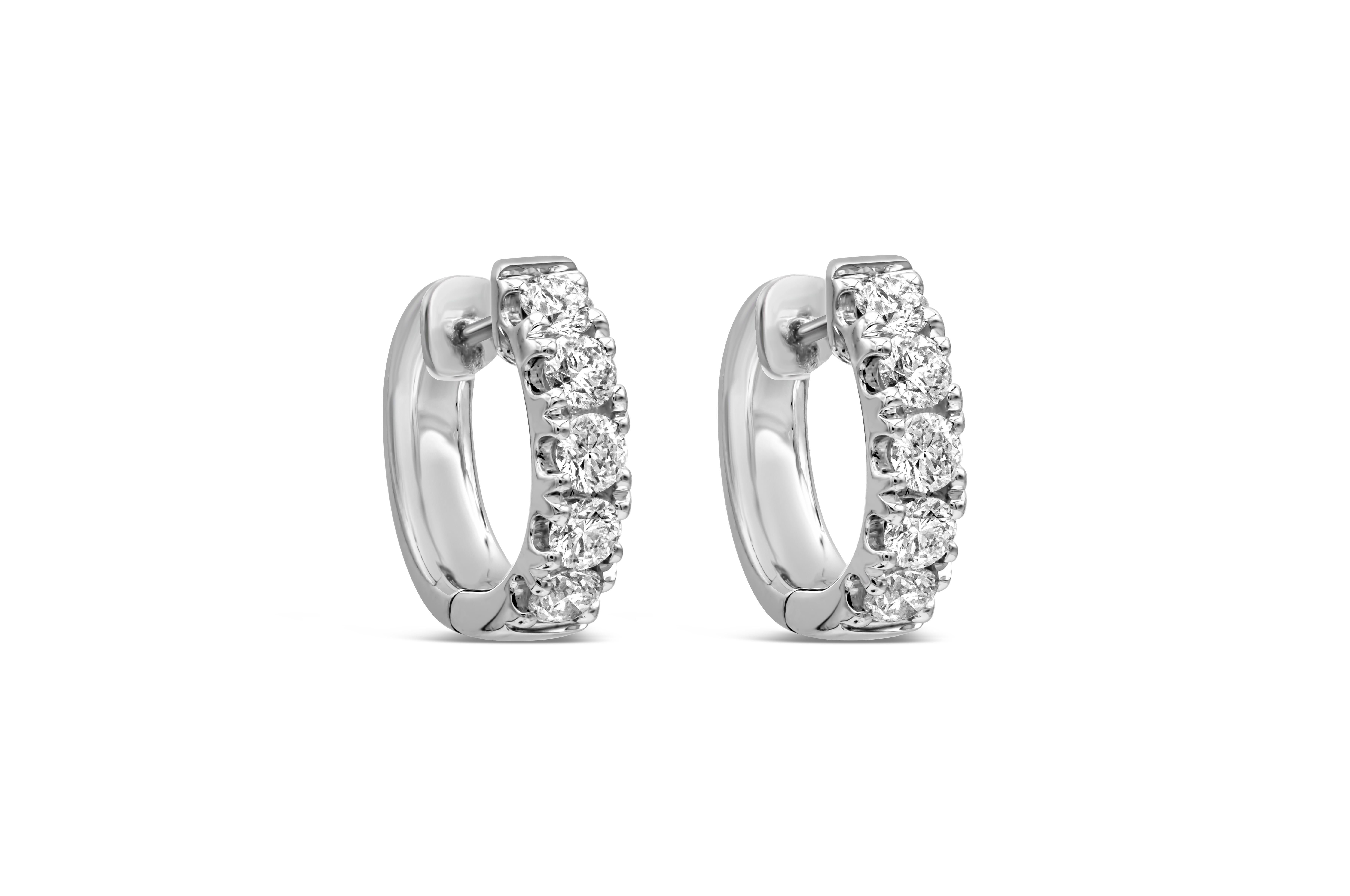 This pair of huggie earrings shows a total of 10 brilliant round diamonds. Diamonds weigh 1.00 carats total. Aprroximately F-G color, VS-SI clarity. Made in 18k white gold.

Roman Malakov is a custom house, specializing in creating anything you can