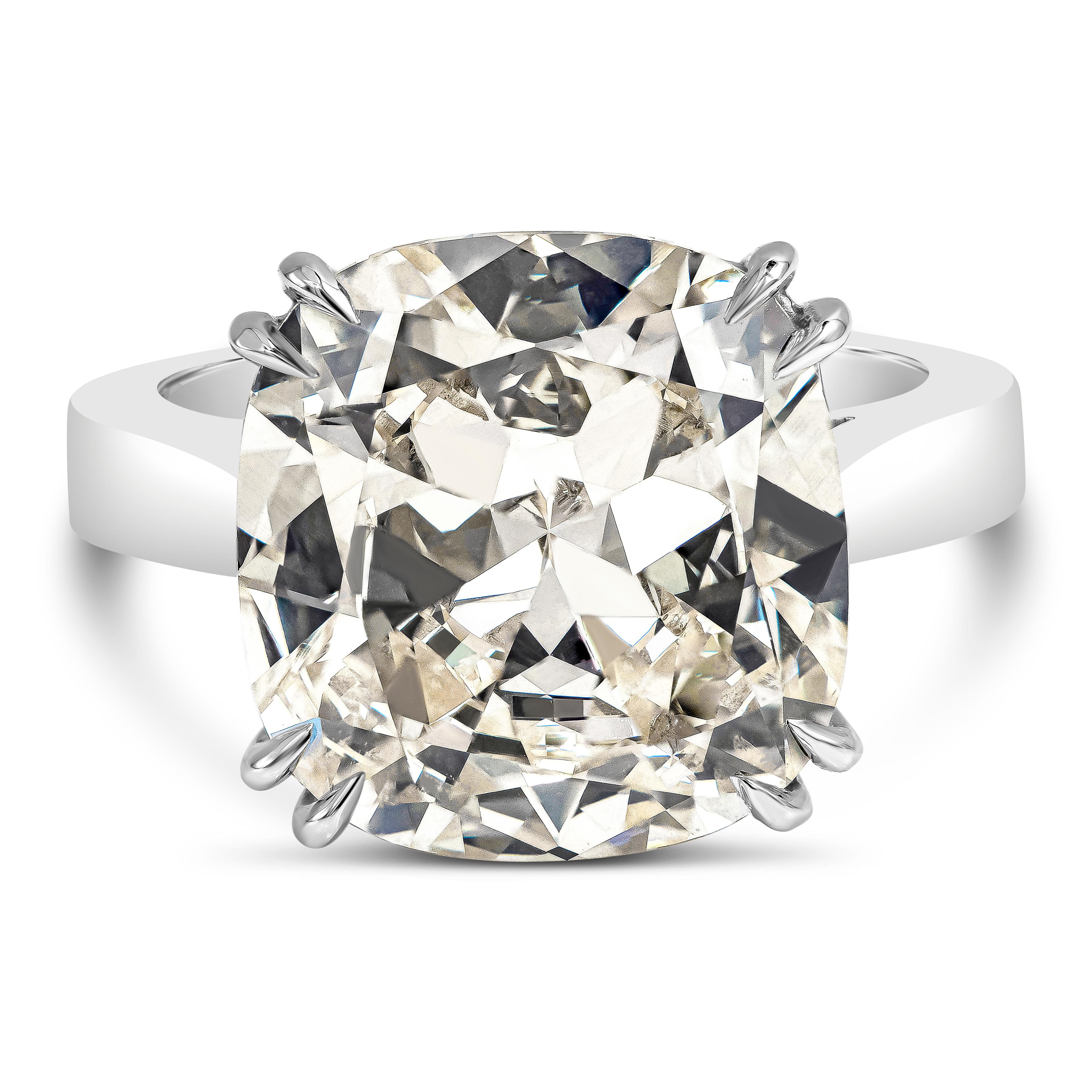 This is an absolutely unique piece. It features a 10.05 carat cushion cut diamond set in a double eagle prong platinum setting. Because of the strong blue fluorescence of this ring, it looks colorless (D color) in natural daylight. It only has a