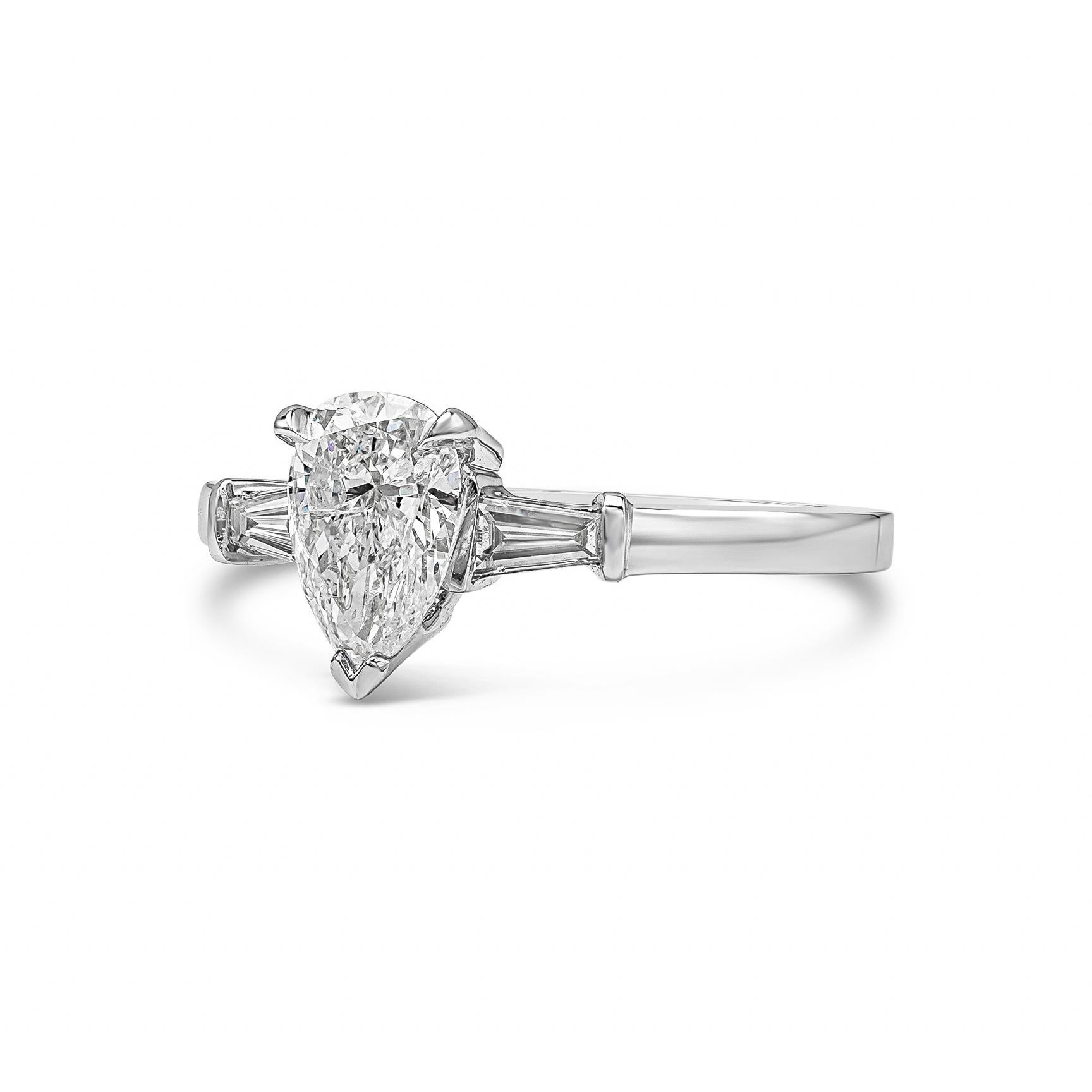 A timeless three stone engagement ring style, showcasing a 1.01 carats pear shape diamond, flanked by two tapered baguette cut diamonds weighing 0.18 carats total. Set on 18K white gold. Size 6.5 US, adjustable upon request.

Roman Malakov is a