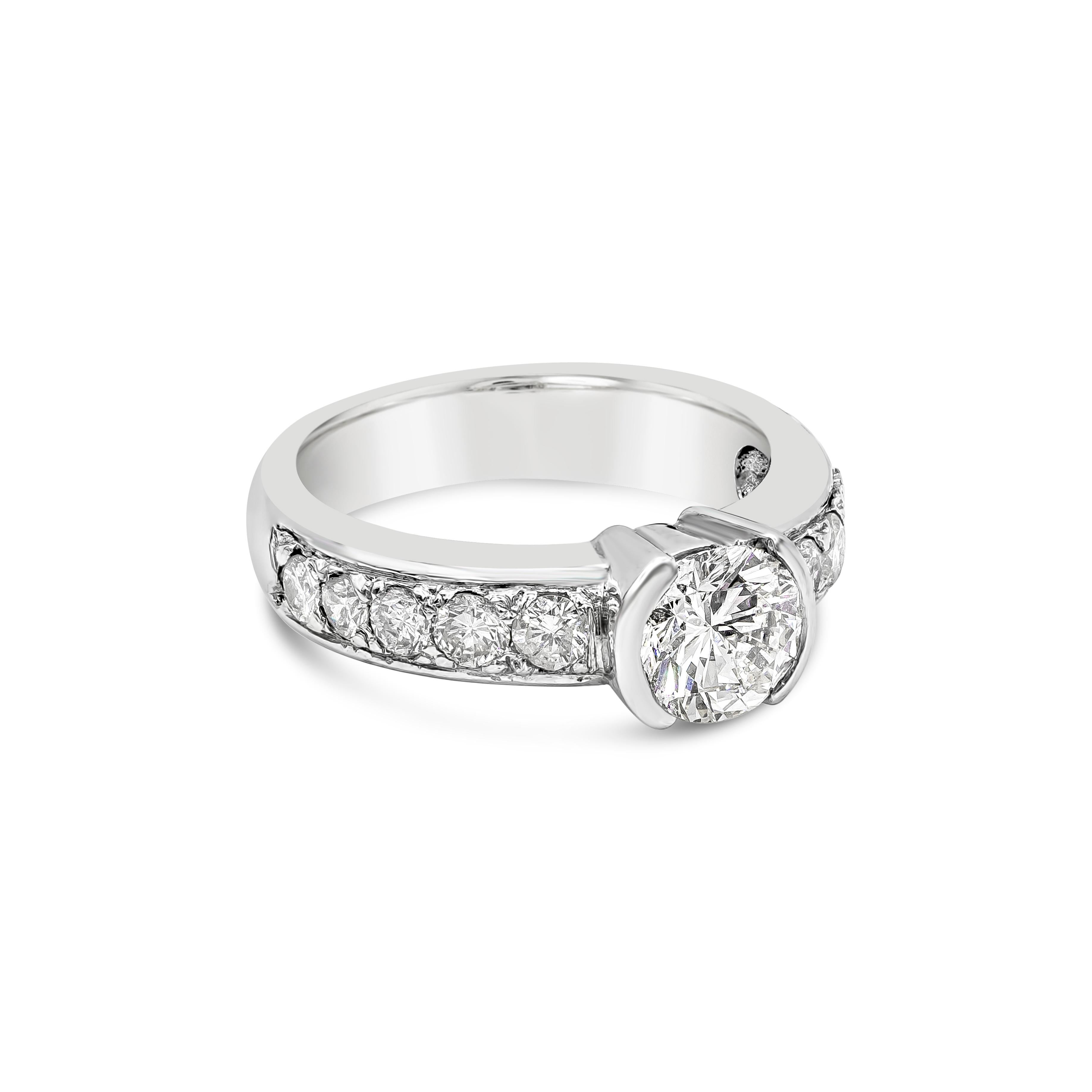 This gorgeous ring has a beautiful unique half bezel design with a 1.01 carat brilliant round diamond. The center stone is accented with a single row of brilliant round diamonds that set on each side of the ring which weighs about 0.51 carats in