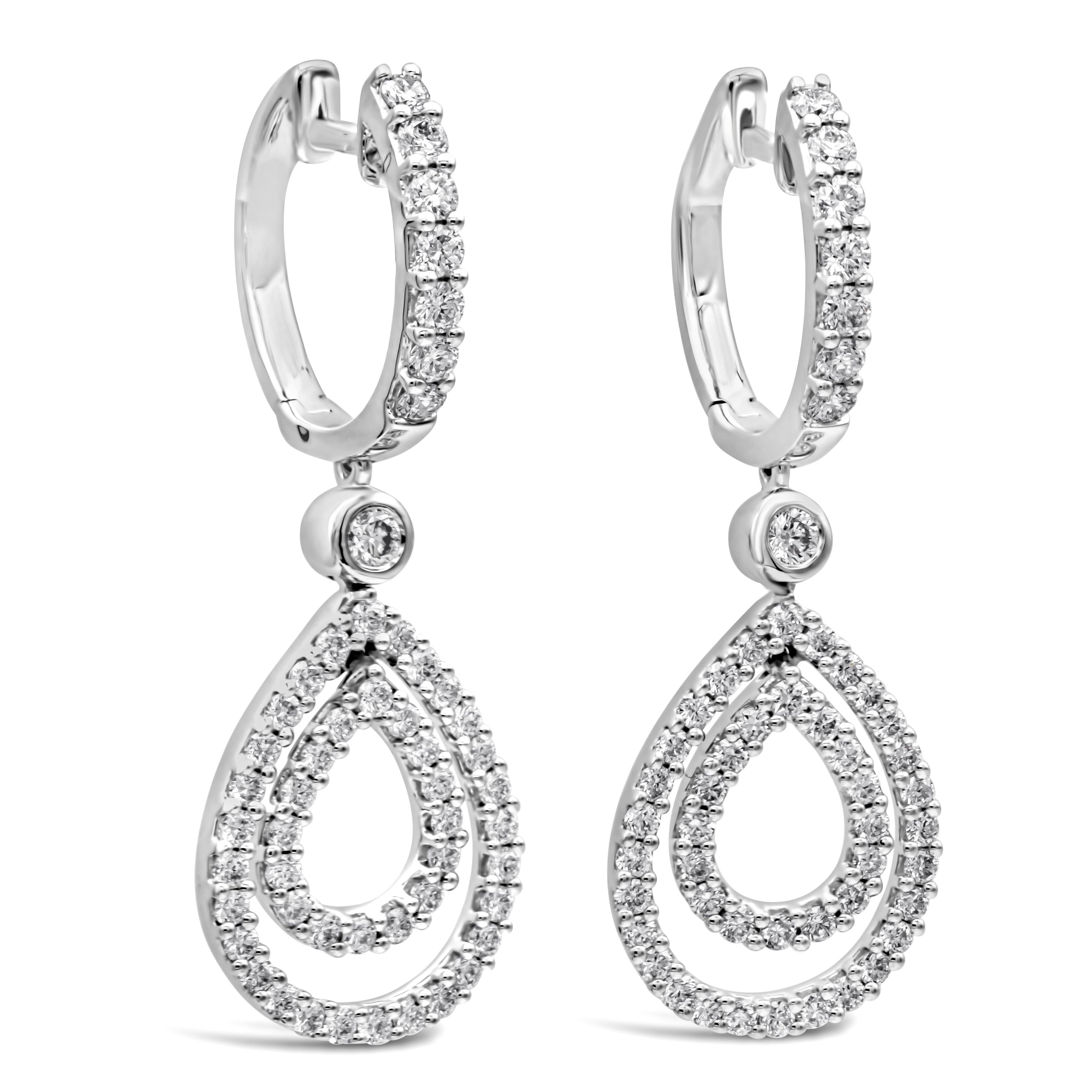 This classy dangle earrings showcasing a brilliant round cut diamonds set in a beautiful double pear shape halo open-work design weighing 1.04 carats total, F-G color and VS-SI in clarity. Attached to an accented lever-back settings made in 18k