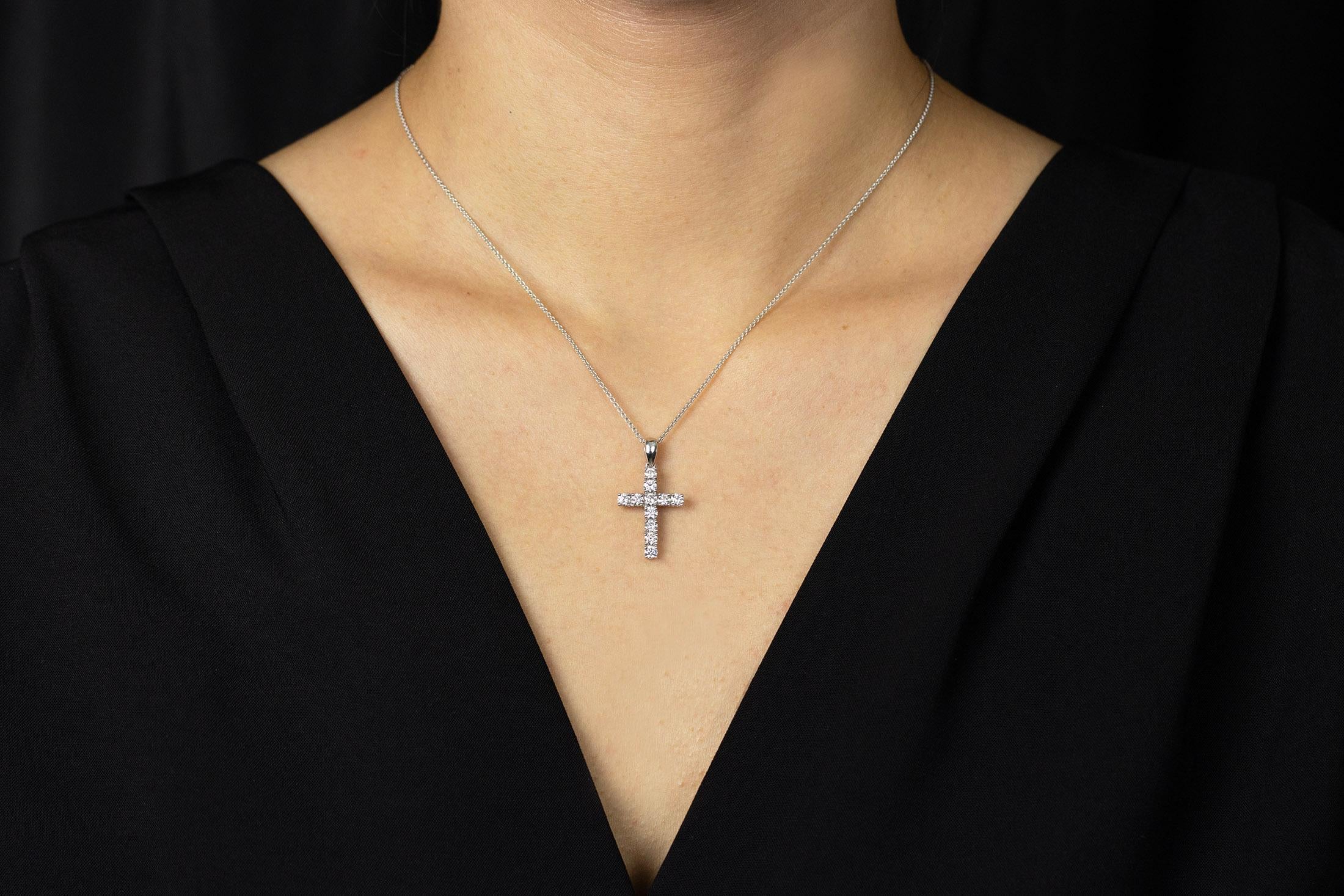 A classic yet endearing cross pendant necklace made in 18k white gold, set with round brilliant diamonds weighing 1.05 carats total. Suspended on an 18 inch adjustable white gold chain.

Style available in different price ranges. Prices are based on