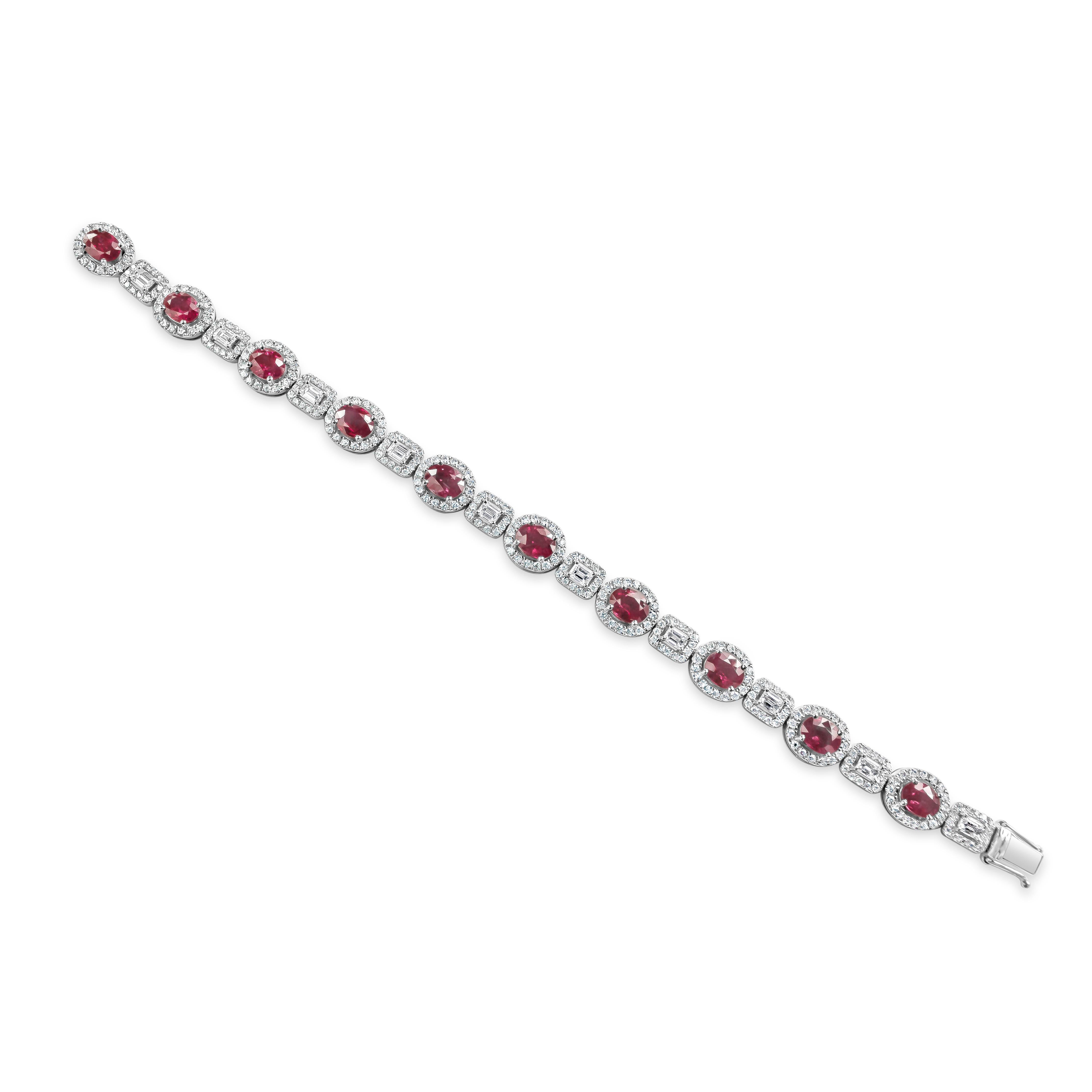 An exquisite elegant bracelet showcasing a color-rich oval cut rubies weighing 7 carats total. Evenly spaced by emerald cut diamonds weighing 1.36 carats. Surrounding the rubies and emerald diamonds are round melee diamonds in a halo design weighing