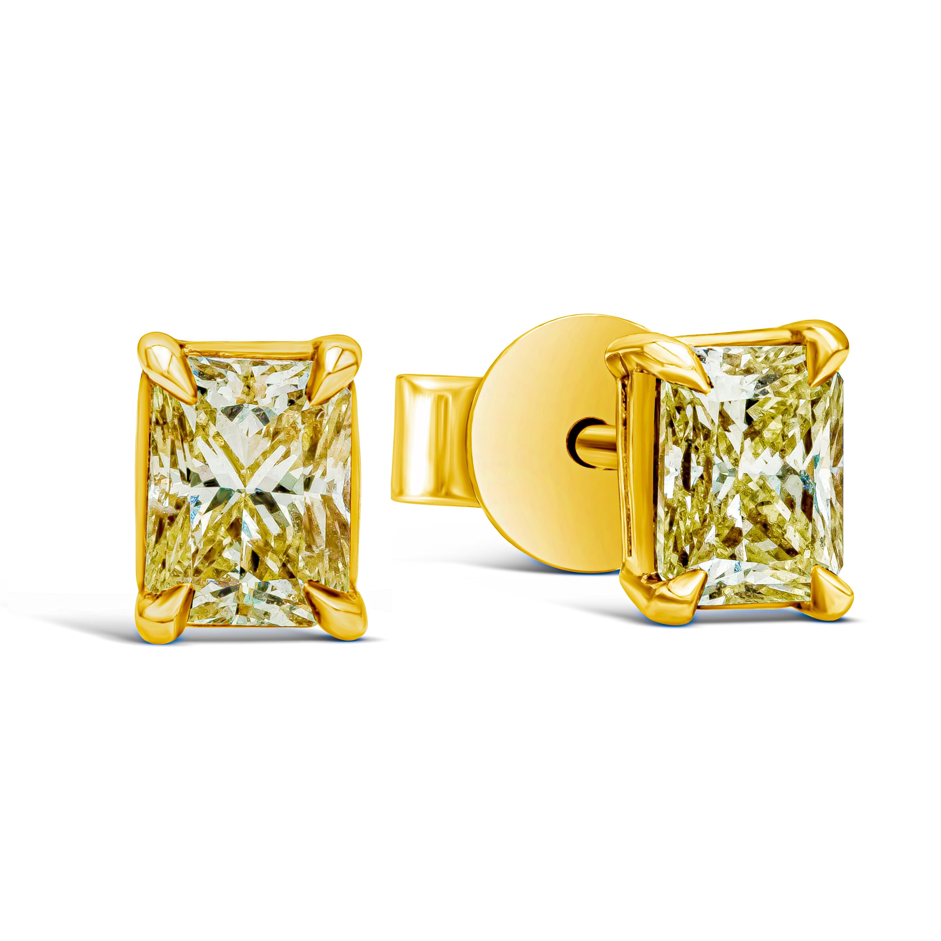 Features a beautiful pair of yellow diamond stud earrings showcasing two elongated radiant-cut diamonds weighing 1.07 carats total. The diamonds are Fancy Intense Yellow in color and VS in clarity. Set in a four-prong basket setting. Made with 18K