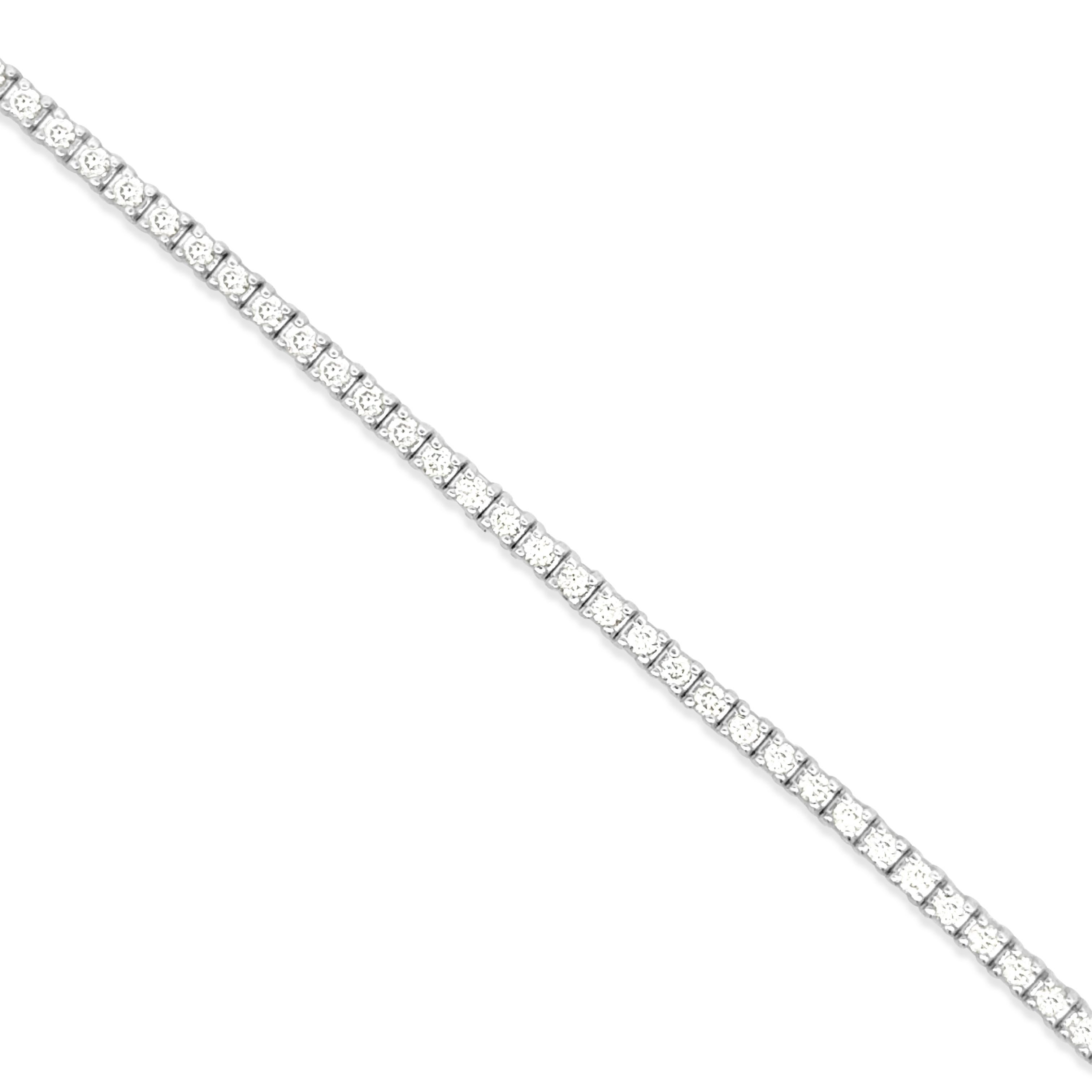 A classic tennis bracelet, featuring 82 round brilliant cut diamonds weighing 1.08 carats total with F color and SI1 clarity. Finely made with 18K white gold, 7 inches in length and 1.5 mm in width. Perfect for casual wear. 

Roman Malakov is a