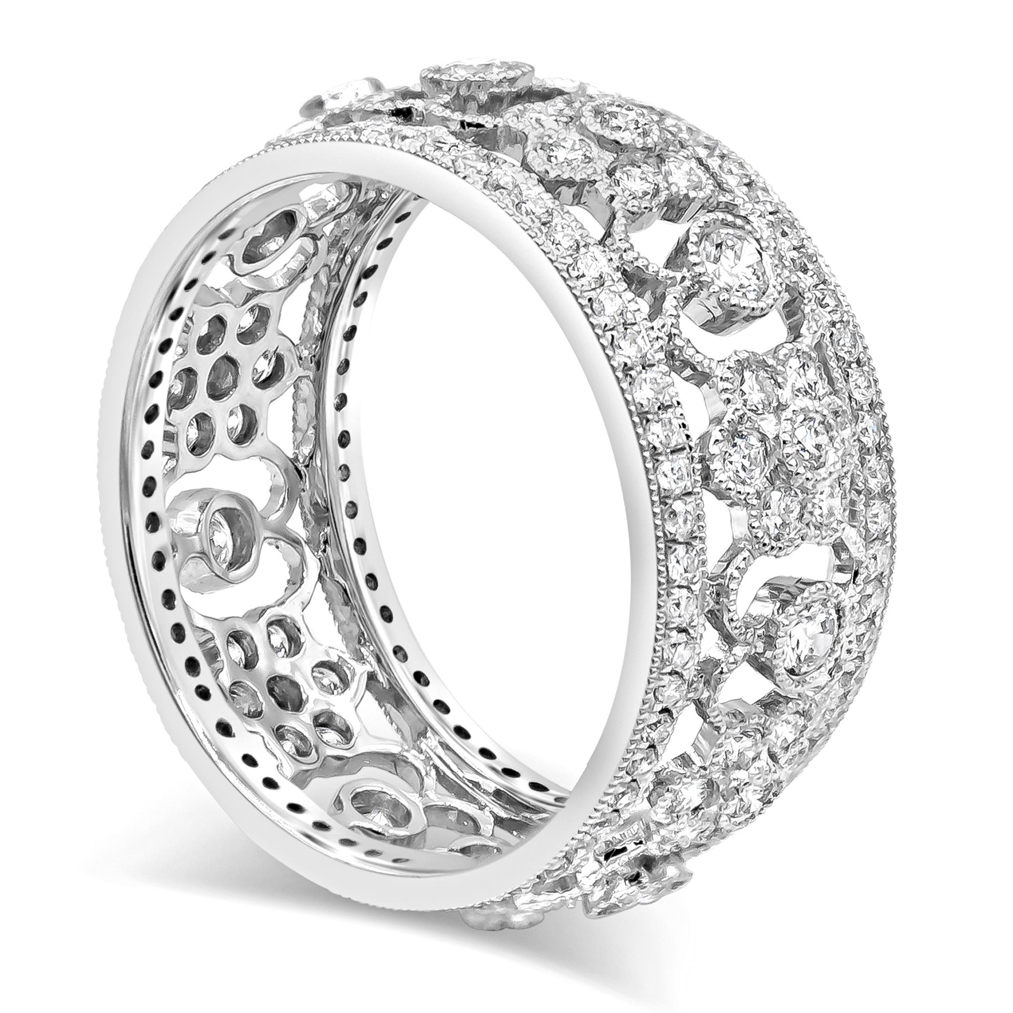 An antique style open-work wedding band showcasing brilliant round diamonds, set in an intricate floral-motif design. Diamonds weigh 1.12 carats total. Made in 18K White Gold. Size 6.5 US resizable upon request and 9mm in width.

Style available in