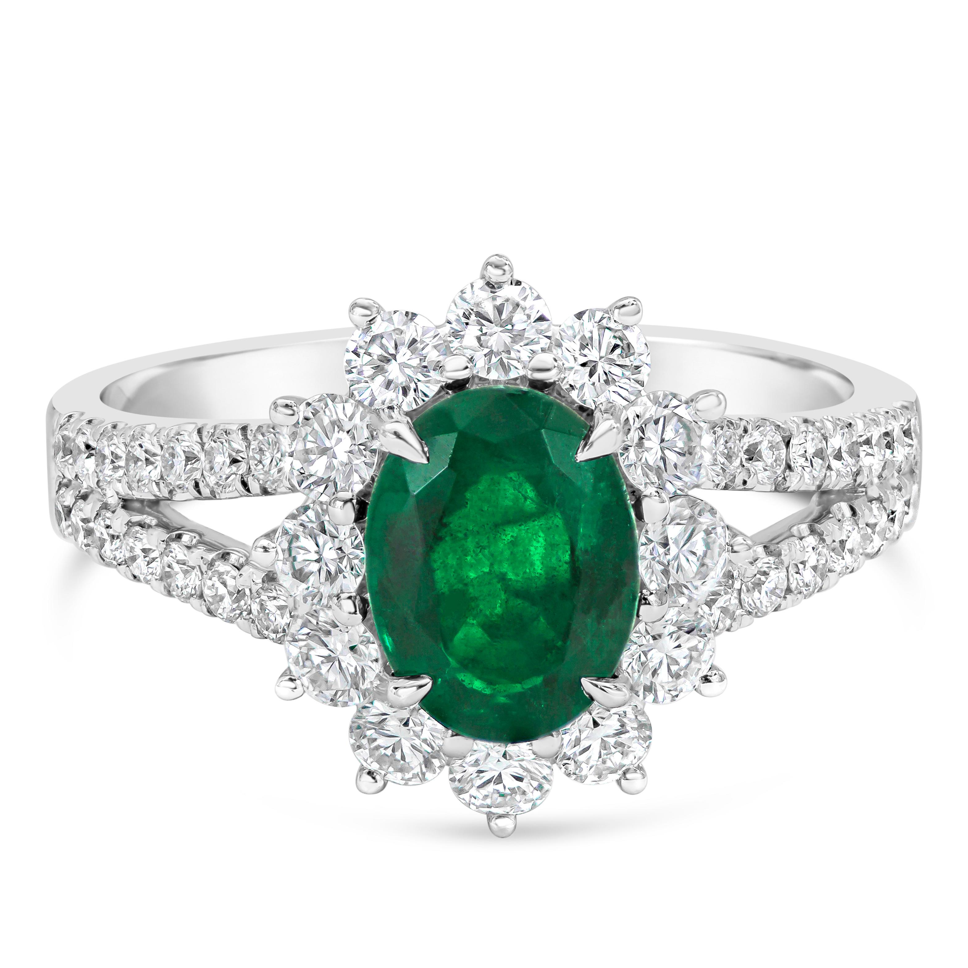 A stunning and color-rich engagement ring, featuring a 1.17 carats oval cut green emerald that embodies calmness and everlasting love. Surrounded by a beautiful halo of round cut diamonds that continue on to a split-shank in a half infinity setting,