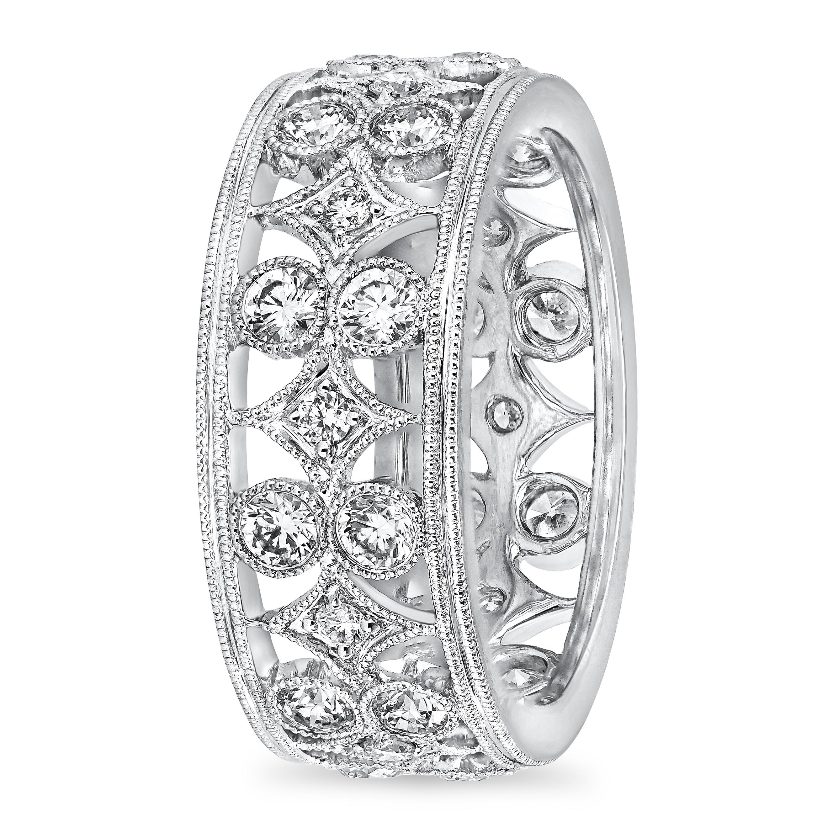 A fashionable and exquisite wedding band showcasing 1.18 carats total of brilliant round diamonds set in a open-work intricate design. Hand engraved with milgrain edges for an antique finished. Finely set in 18k white gold. Size 6.5 US resizable