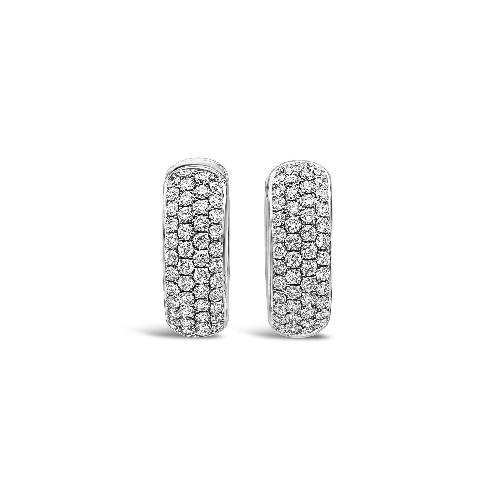 A stylish pair of huggie hoop earrings showcasing round brilliant diamonds weighing 1.19 carats total, micro-pave set in a domed setting, made in 18k white gold. Diamonds are approximately F color, VS-SI1 in clarity.

Roman Malakov is a custom