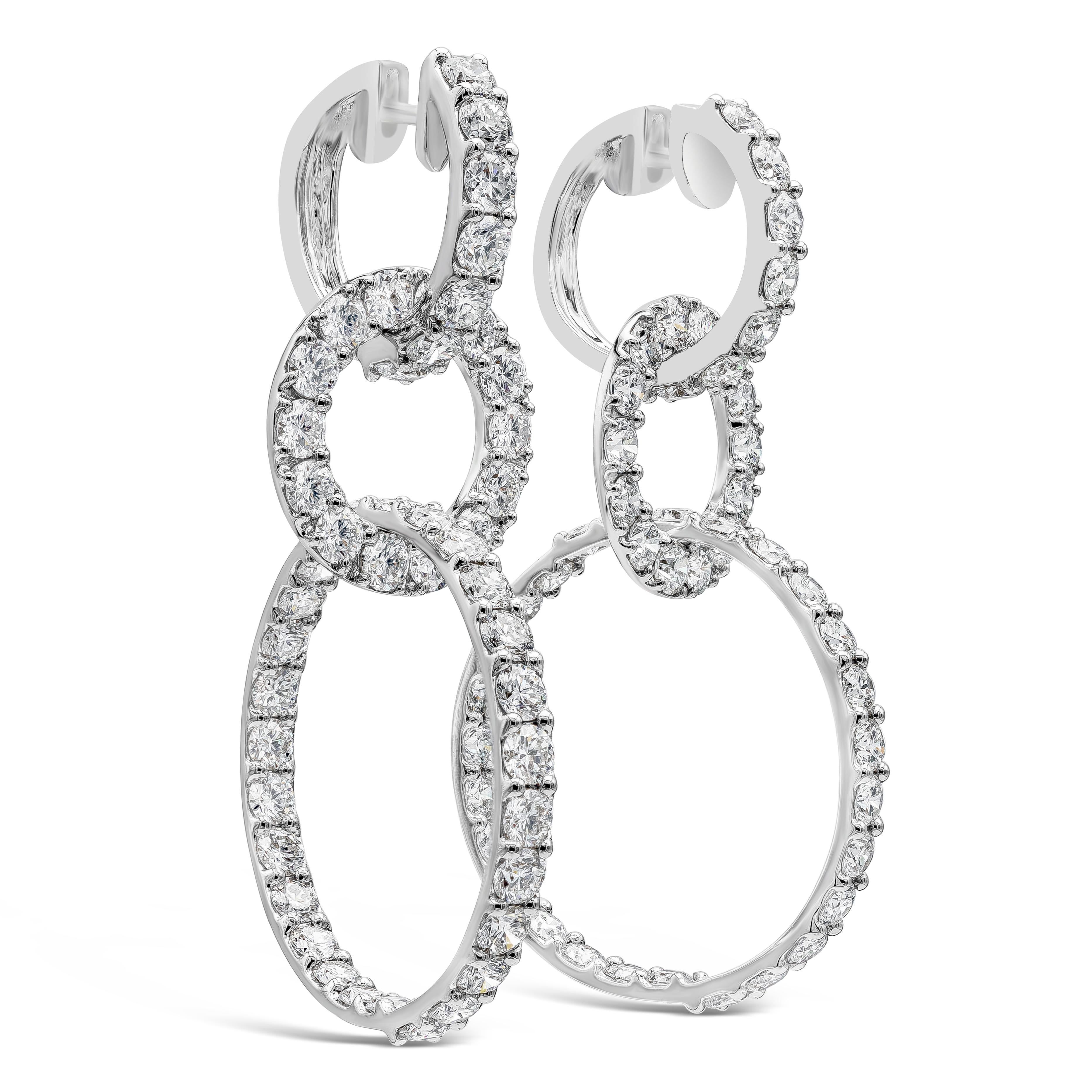 Boucle d'oreille goutte d'eau chic composée de 96 diamants ronds brillants dans un design à triple anneau. Les diamants pèsent 12,15 carats au total, de couleur F-G et de pureté VS-SI. Fabriqué en or blanc 18 carats ; longueur de 2,20 pouces.

Roman