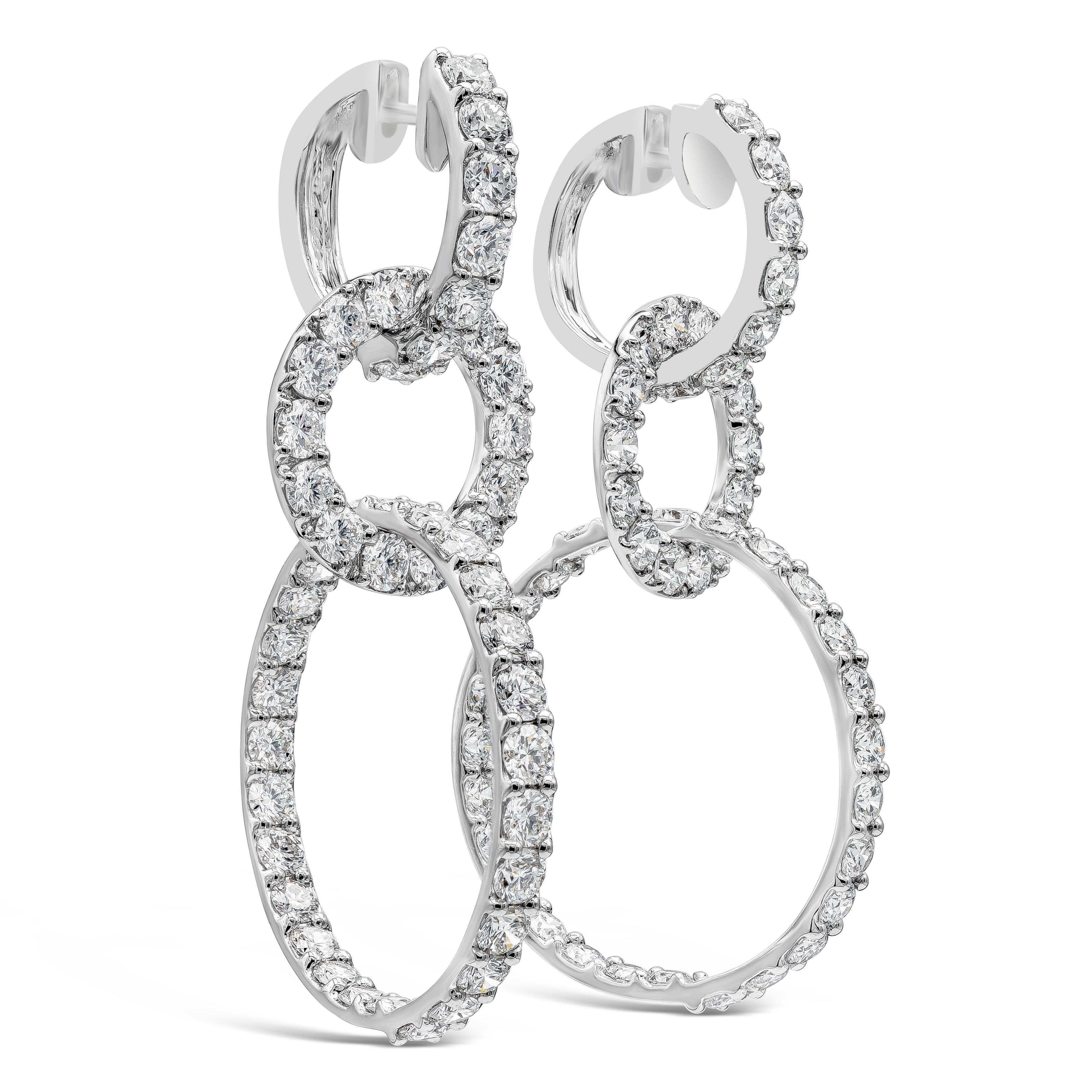 Boucle d'oreille goutte d'eau chic composée de 96 diamants ronds brillants dans un triple anneau. Les diamants pèsent 12.15 carats au total, de couleur F-G et de pureté VS-SI. Fabriqué avec de l'or blanc 18 carats. Longueur de 2,20 pouces.

Roman