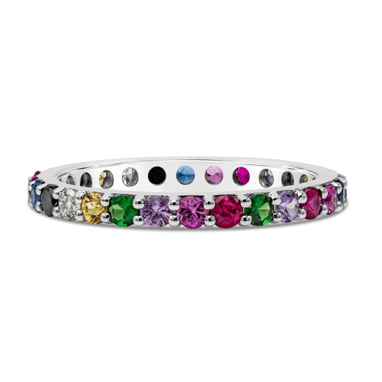   A unique band set with different color gemstones and diamonds in an 18k white gold mounting. Diamonds weigh 0.23 carats total; gemstones weigh 1.00 carats total. Size 6.5 US.

