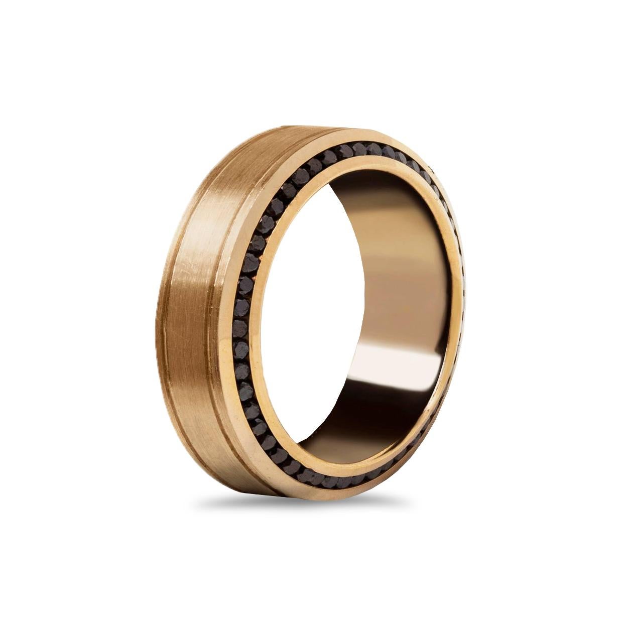 A comfort fit wedding band wrapped with black diamonds weighing 1.23 carats total; channel set on each side of the ring. Two lines finely-engraved in the middle portion of the ring and made in 18k rose gold. Gorgeous brushed inlay finish. Size 10.25