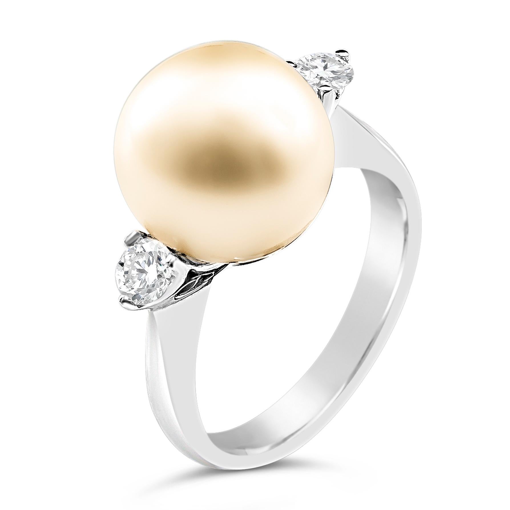 A classy cocktail ring, showcasing one 12.00 millimeter golden south sea pearl flanked by two round brilliant cut diamonds weighing 0.32 carat total. Finely made with 18K white gold. Size 7 US, resizable upon request. 

Roman Malakov is a custom