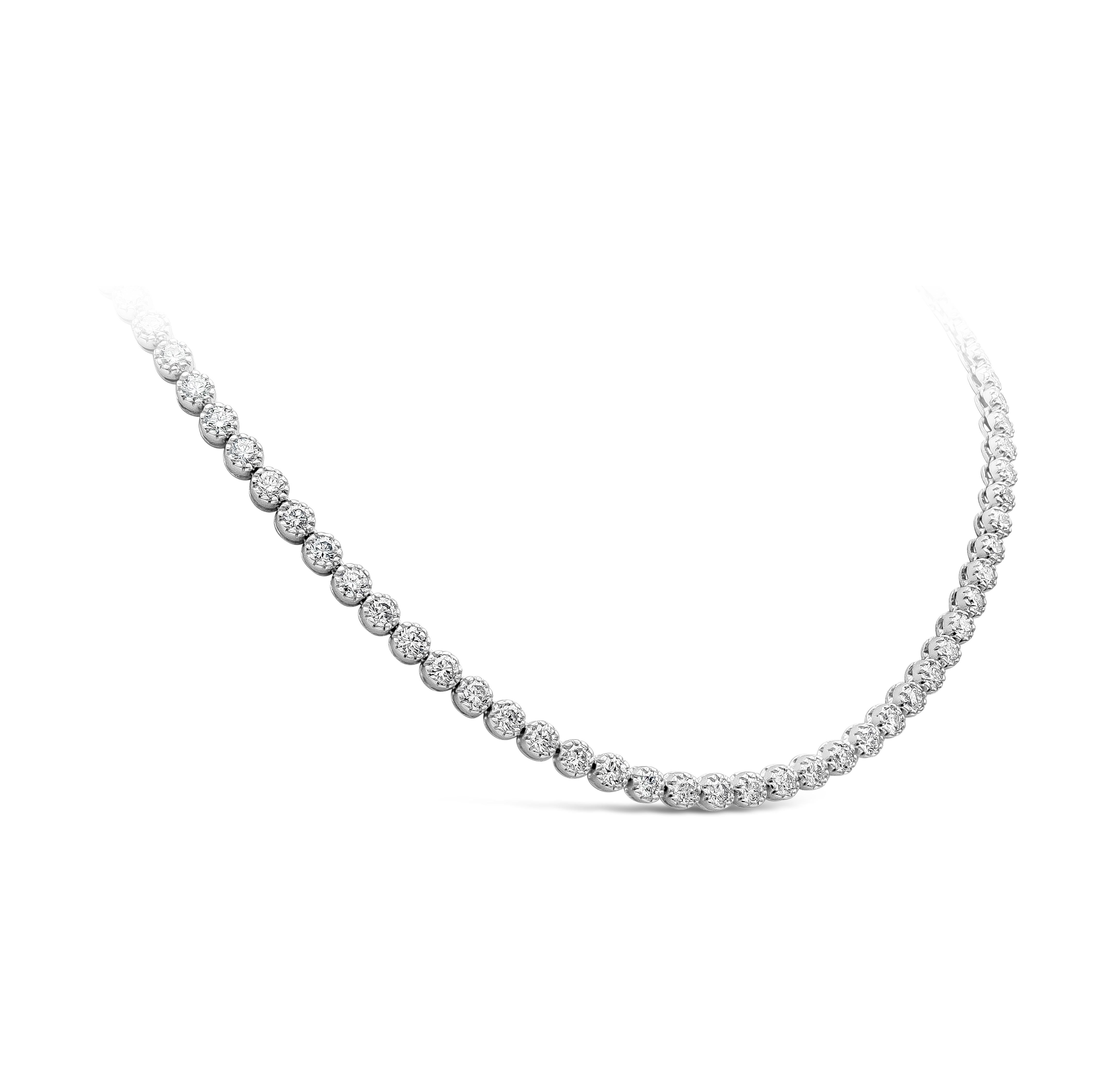 A stylish and classy tennis necklace style showcasing a row of round brilliant diamonds weighing 13.27 carats total, set in a ten-prong style mounting made in 18K white gold. Diamonds are approximately D - F color, SI clarity. 16.38 inches in