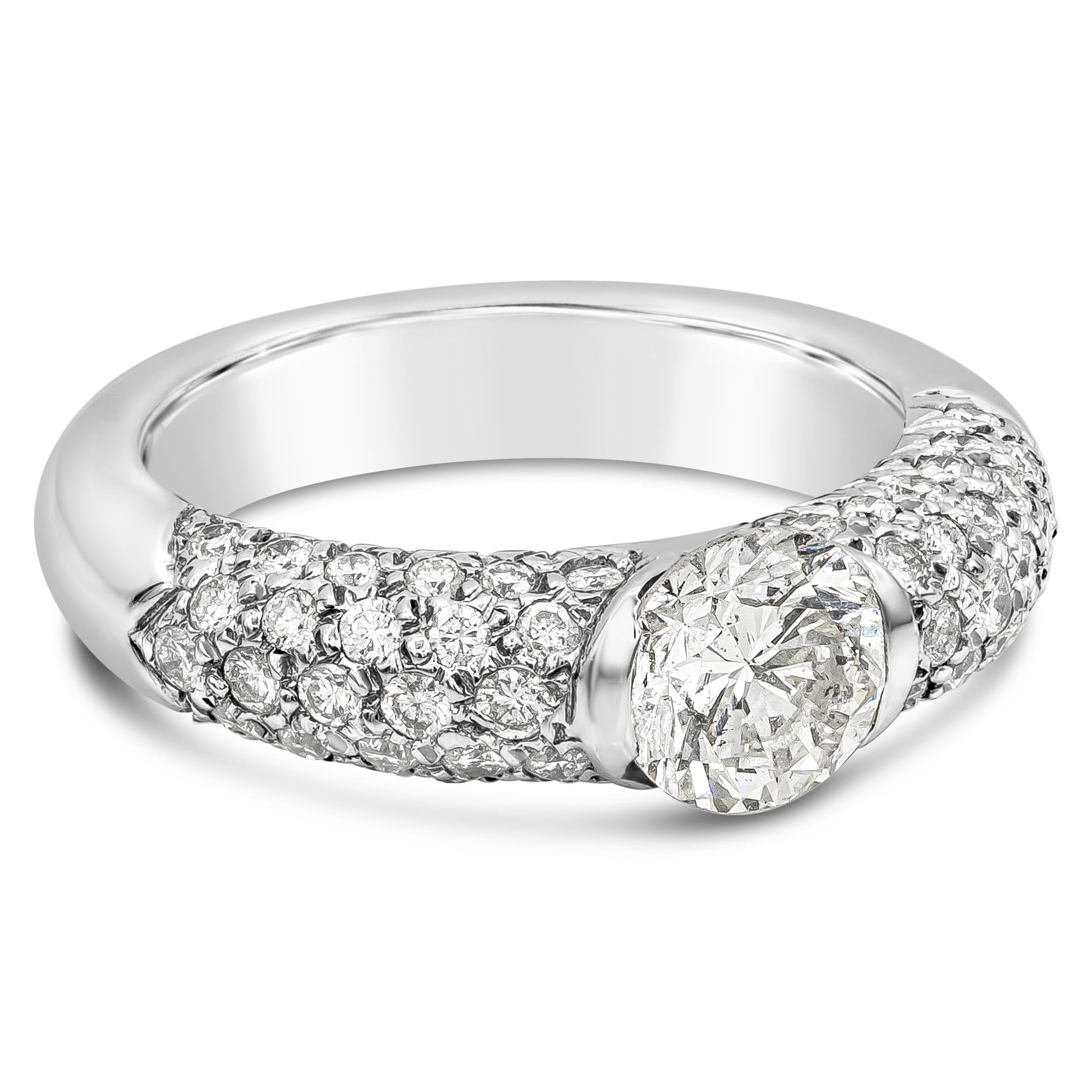 This gorgeous ring has a beautiful unique half bezel design with a 1.35 carats brilliant round diamond center stone, K-L color, SI2 in clarity. Accented by round brilliant melee diamonds on each side weighing 1.04 carats total, set in a pave set