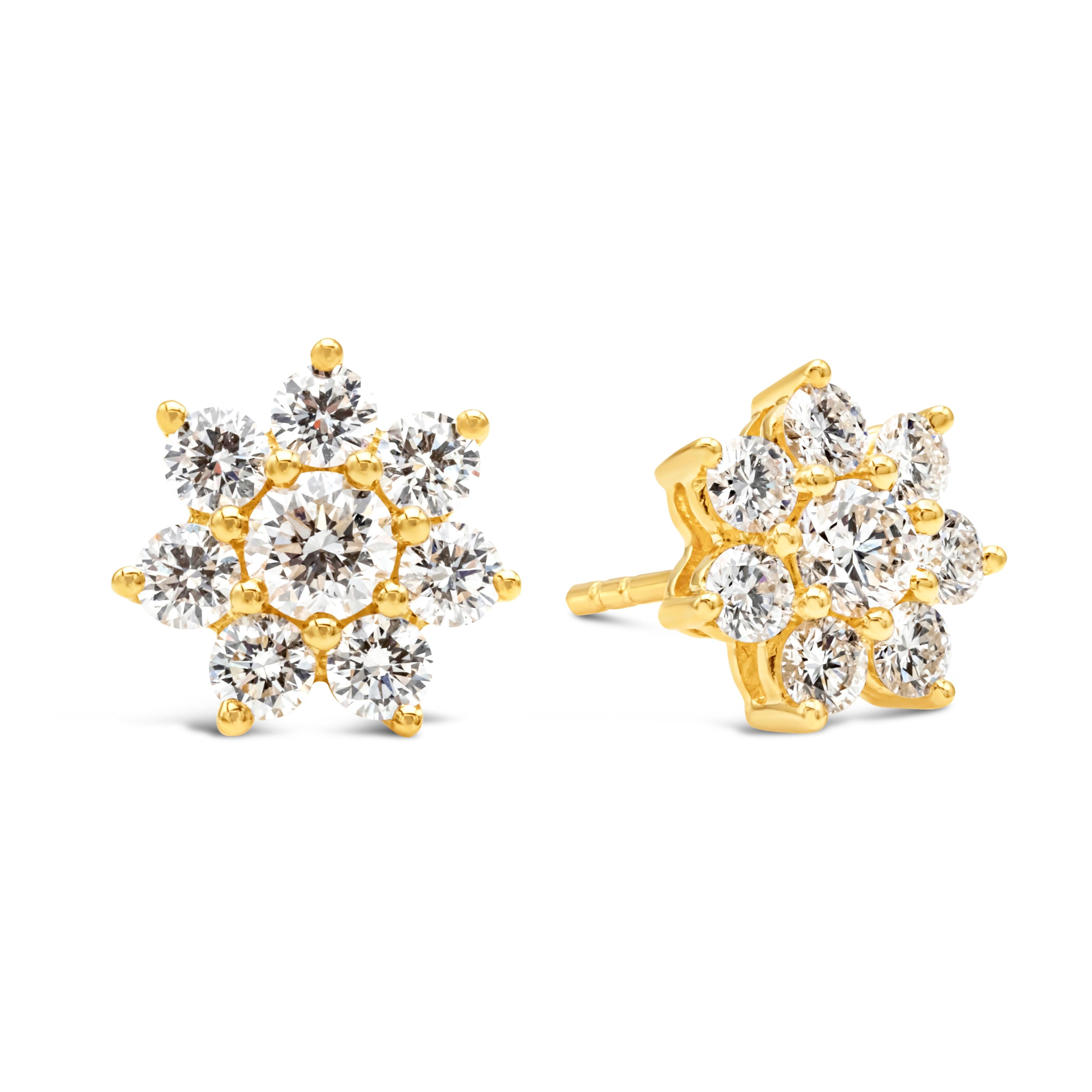 A chic and unique pair of stud earrings showcasing 16 brilliant round shape diamonds weighing 1.35 carats total, F color and VS in clarity, beautifully set in a flower-motif design and shared prong setting. Finely made in 18k yellow gold. A perfect