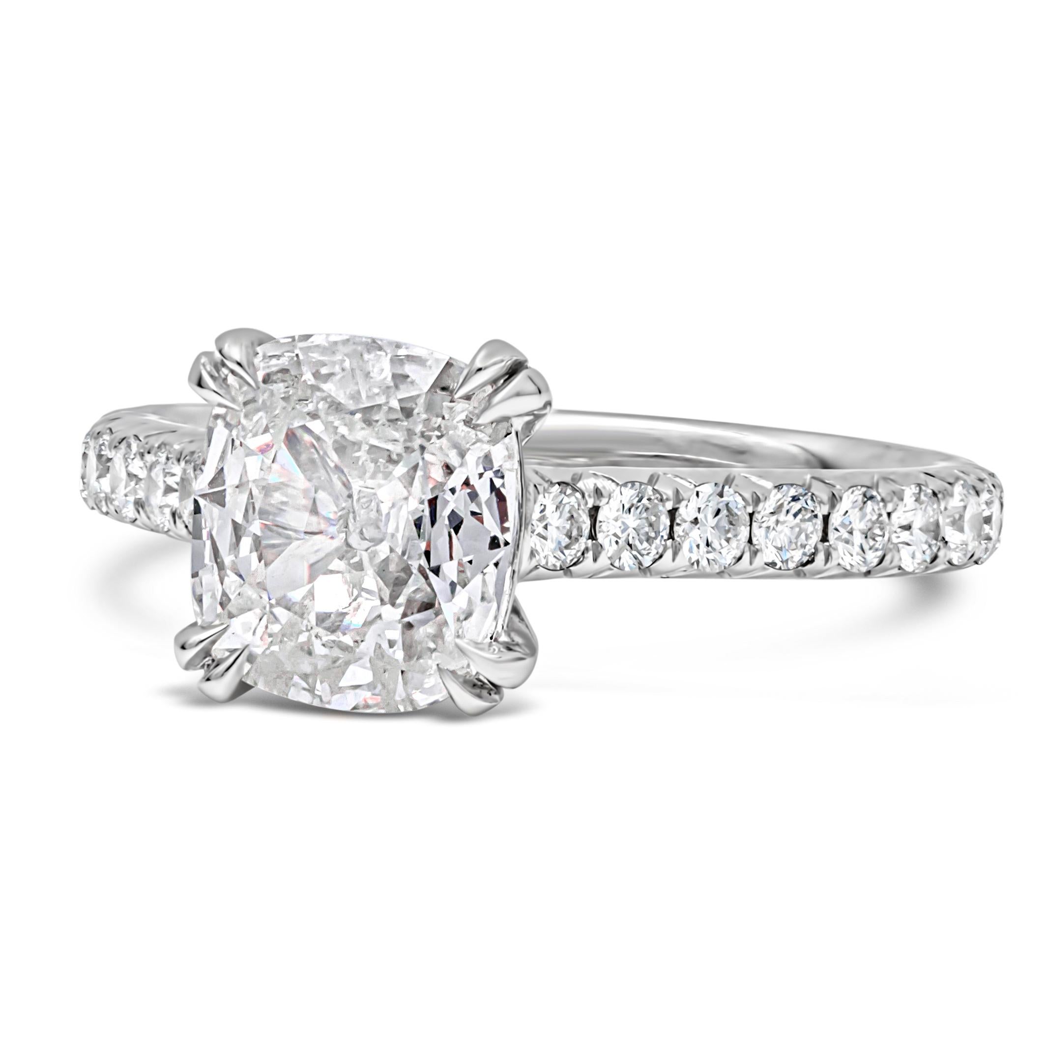 An elegant engagement ring, showcasing a 1.39 carats cushion cut diamond certified by EGL as G color and SI2 clarity, set on four double claw prongs. Accented by a diamond encrusted shank on a pavé setting with a half-way design. Accent diamonds