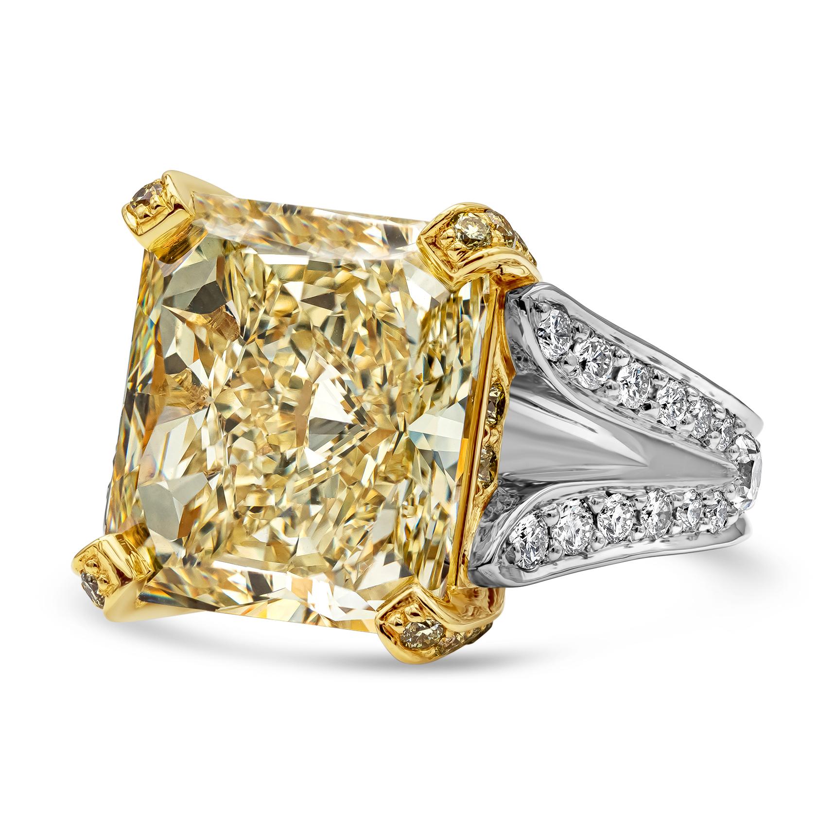 Elegant and luxurious split shank engagement ring showcasing a vibrant and color rich GIA certified 13.95 carat radiant cut fancy yellow diamond, VS1 in clarity. Center stone is set in a four prong 18k yellow gold basket encrusted with yellow