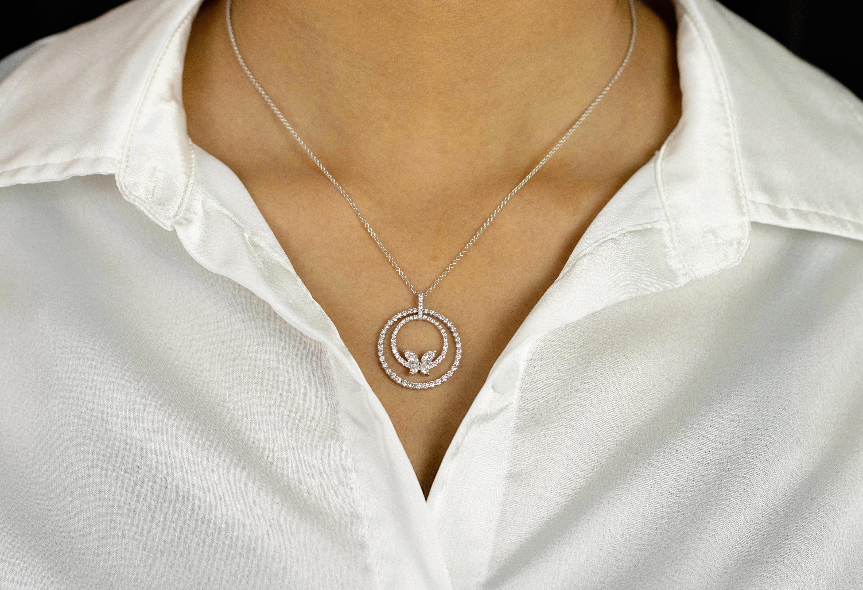 A simple pendant necklace showcasing two concentric circles set with round brilliant diamonds. Finishing the necklace are marquise cut diamonds shaped like a butterfly. Diamonds weigh 1.40 carats total. Made in 18K white gold.

Style available in