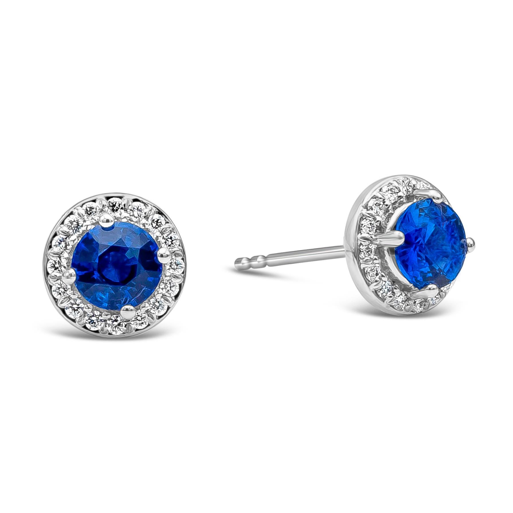 ﻿A simple and versatile pair of stud earrings showcasing 1.28 carats total round blue sapphires surrounded by a single row of brilliant round diamonds weighing 0.14 carats, F Color and VS in Clarity. Made with 18K White Gold.

Style available in
