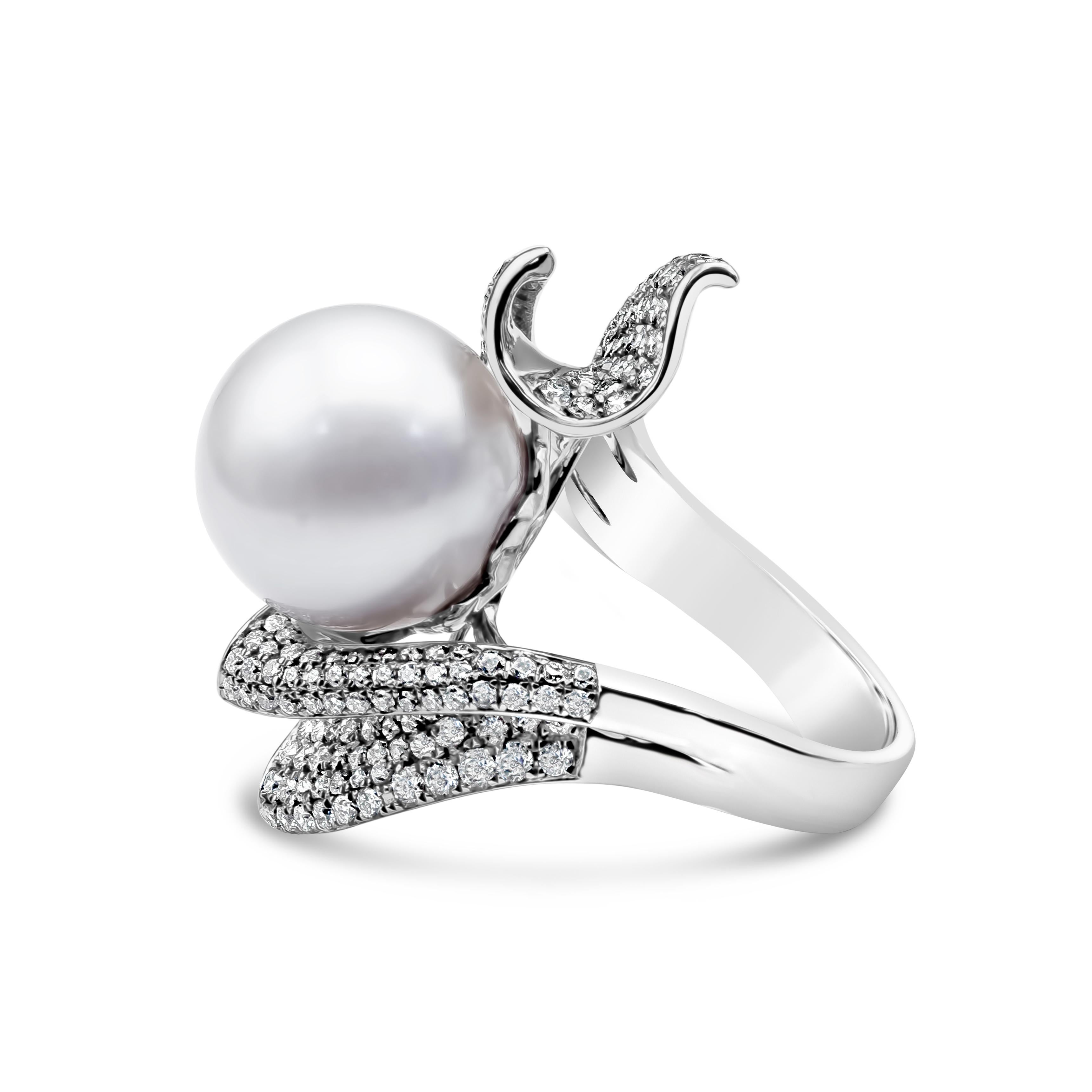 A beautiful and intricately designed cocktail ring showcasing a South Sea pearl accented with 190 round cut diamonds weighing 1.44 carats total. Pearl are approximately 13-14 mm diameter. Set in 18K White Gold setting. Size 6.75 US. Length of the
