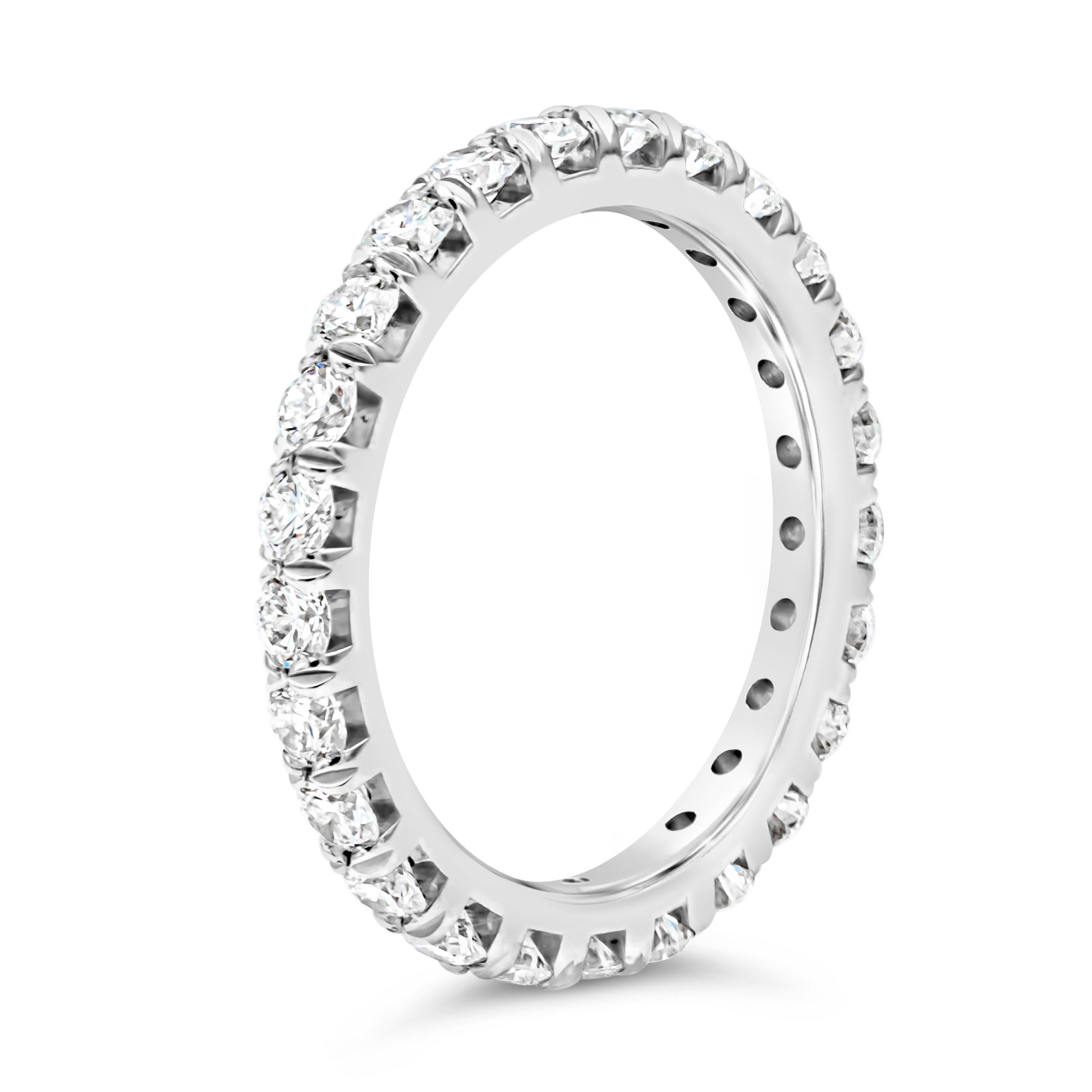 A classic eternity wedding band showcasing a line of 25 brilliant round cut diamonds weighing 1.45 carats total, G color and VS in clarity, set in a four prong basket setting and French pave set. Finely made in platinum. Size 6.5 US resizable upon